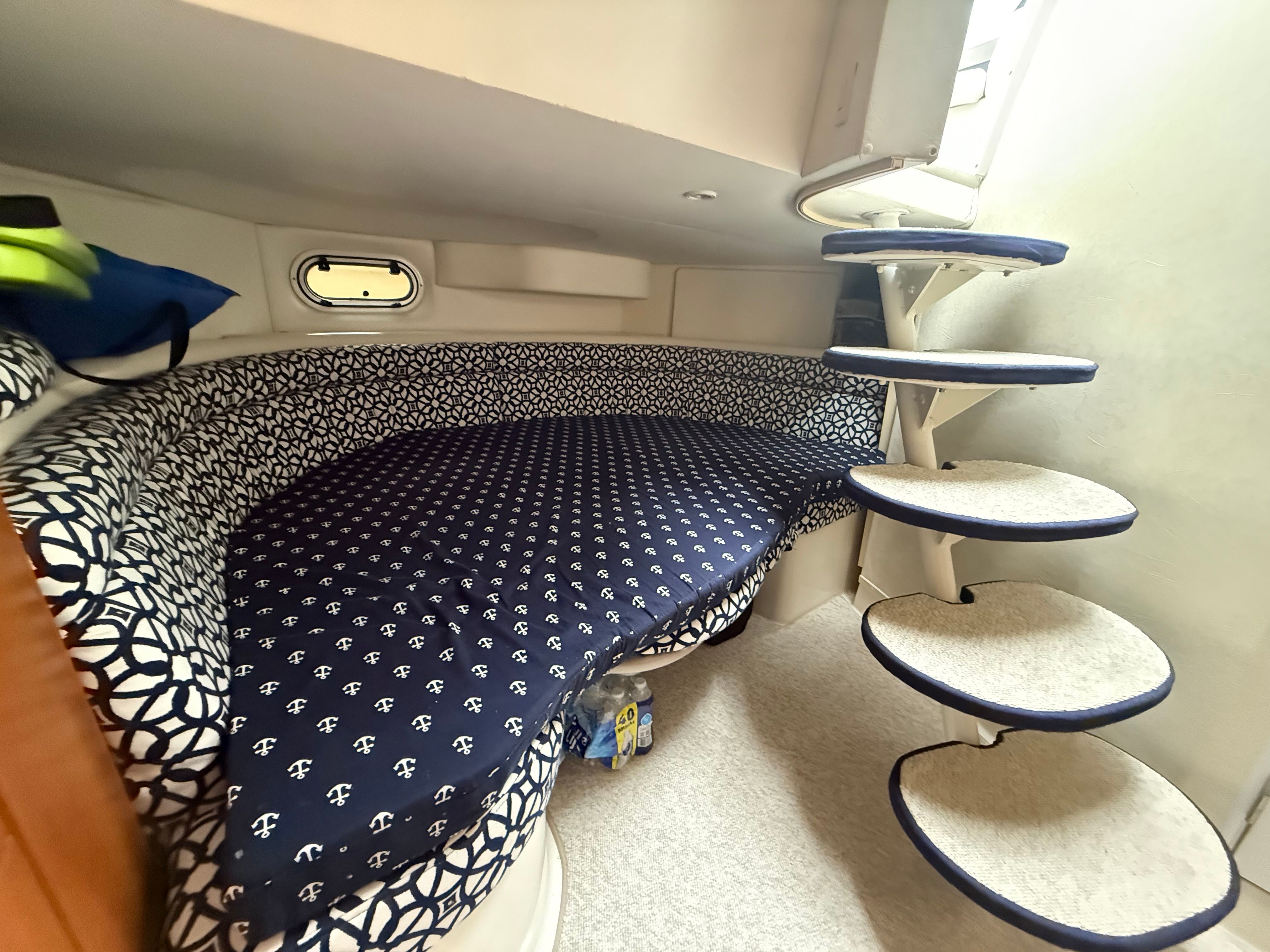 Interior of a 1995 Silverton 360 with cushioned seating area and spiral staircase.