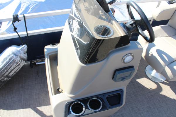 2024 Sun Tracker BB18 boat console with steering wheel and cup holders.