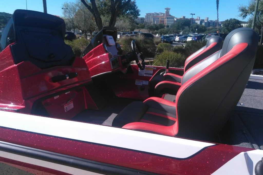 2026 Nitro Z19 XL boat interior with red and black seats, parked outdoors.