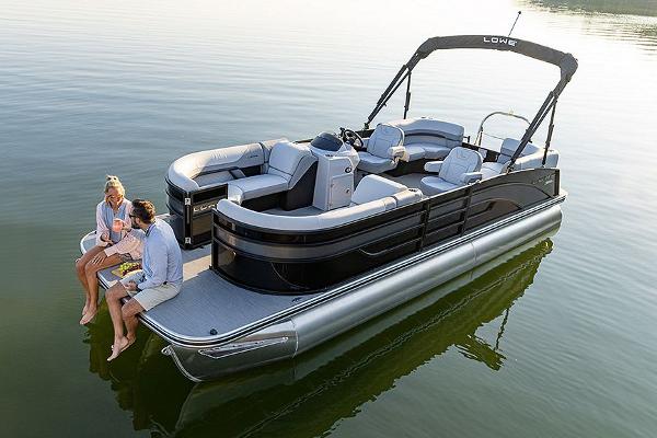 Manufacturer Provided Image: 2025 Lowe SS 230 WV pontoon boat on calm water with two people relaxing.