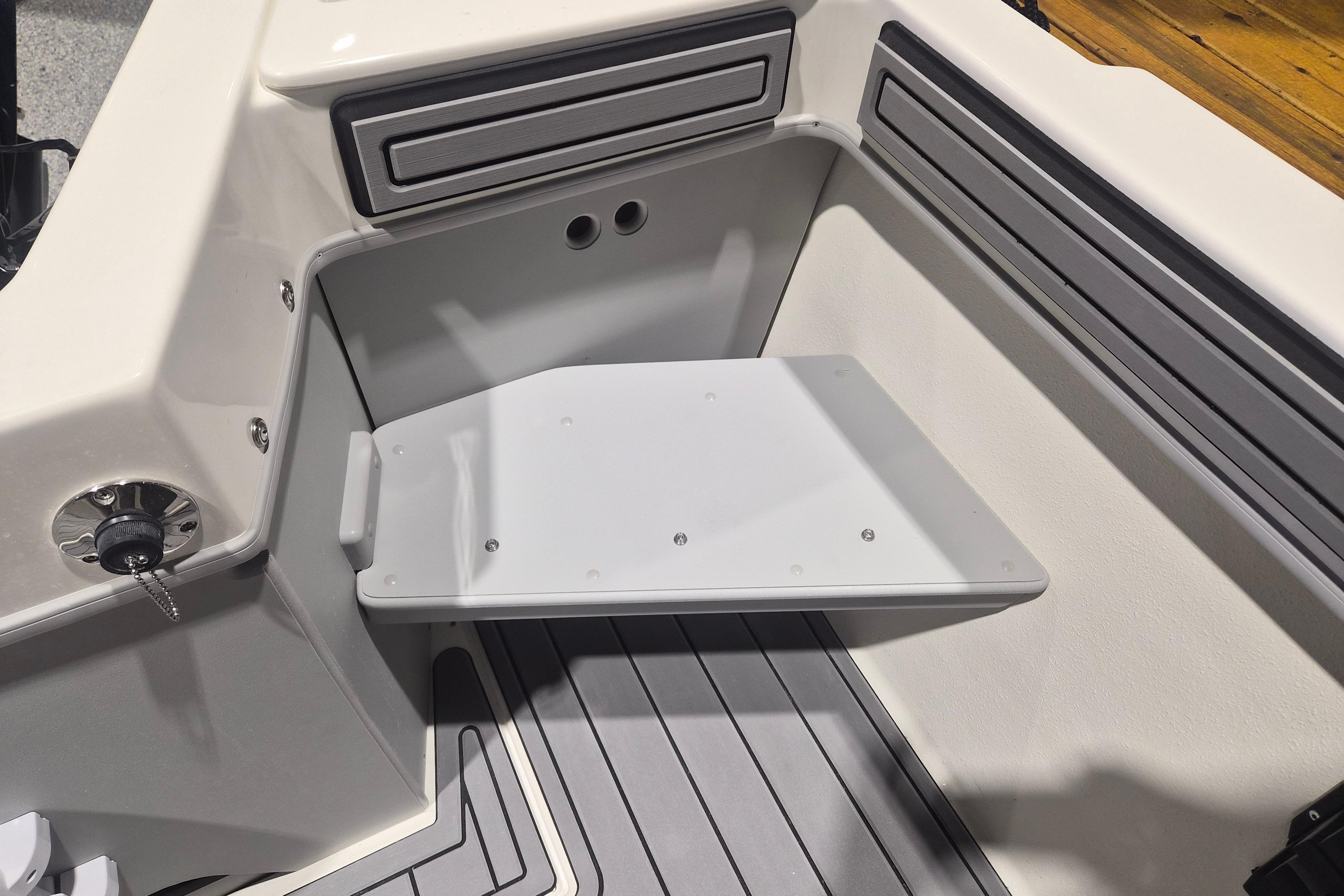 2026 Arima Sea Chaser 19 Yellowtail Edition boat interior with foldable seat and storage.