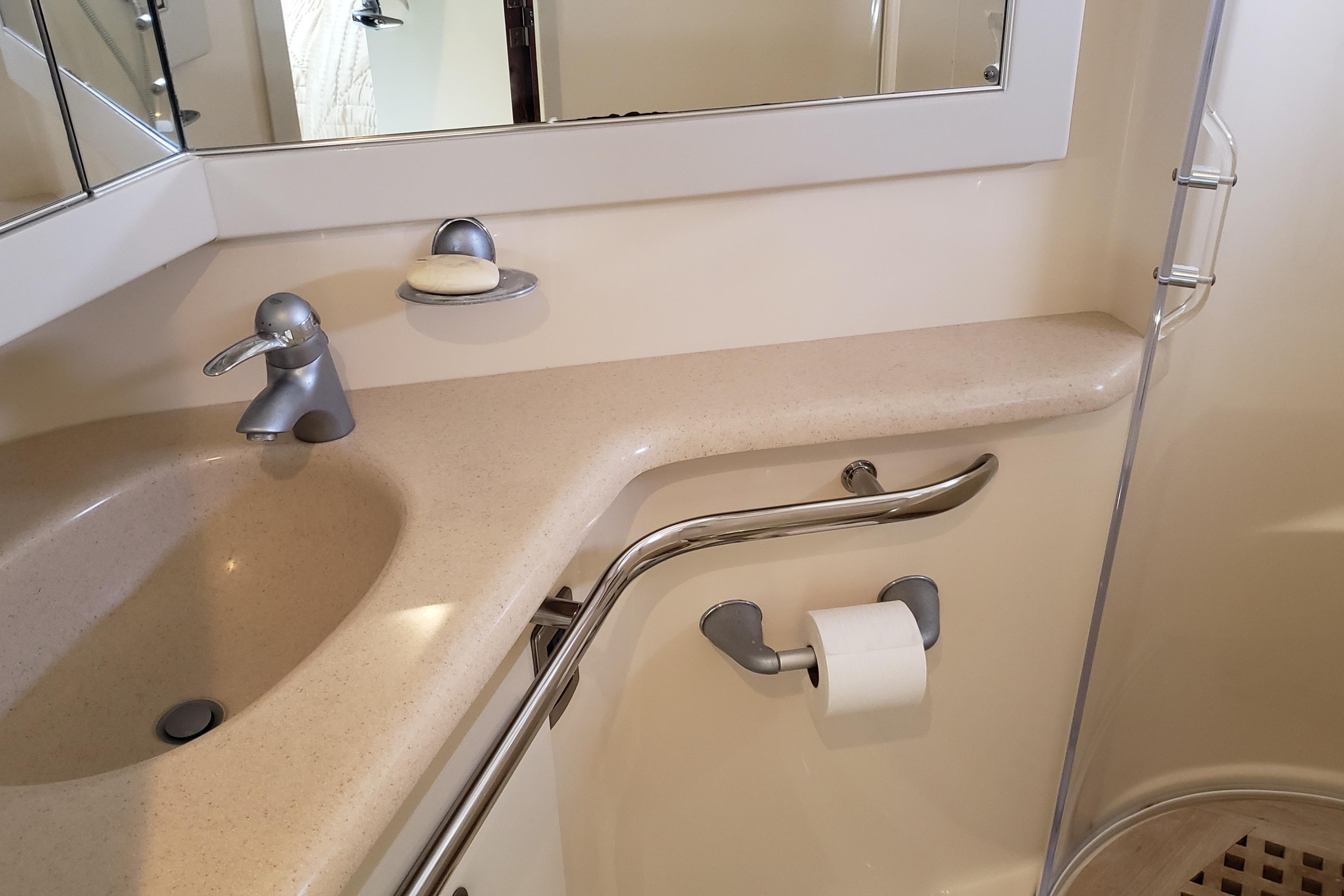 Bathroom sink area in 2004 Sea Ray 550 Sundancer yacht, featuring modern fixtures.