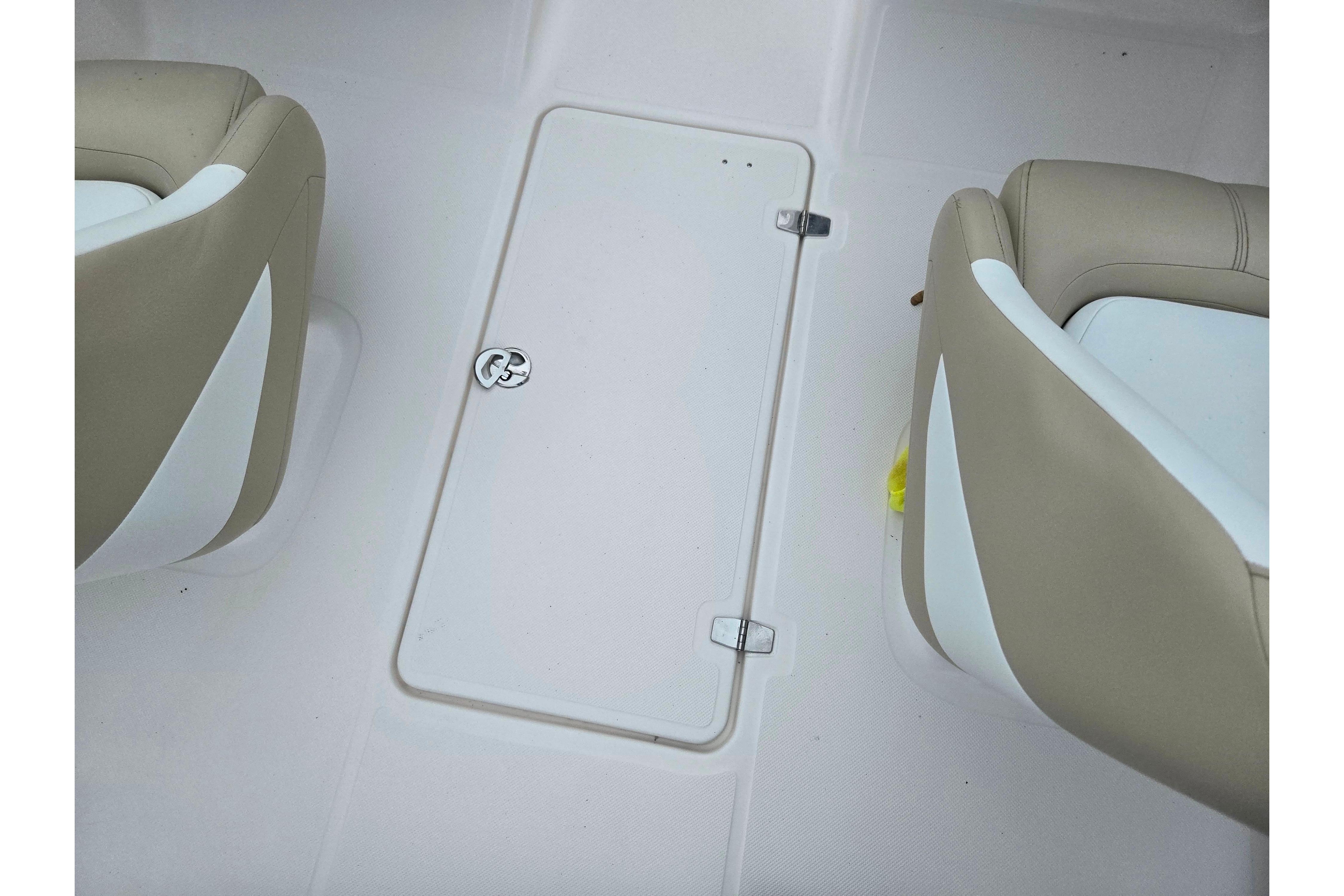 2015 Regal 1900 ES Bowrider interior with beige seats and storage compartment.