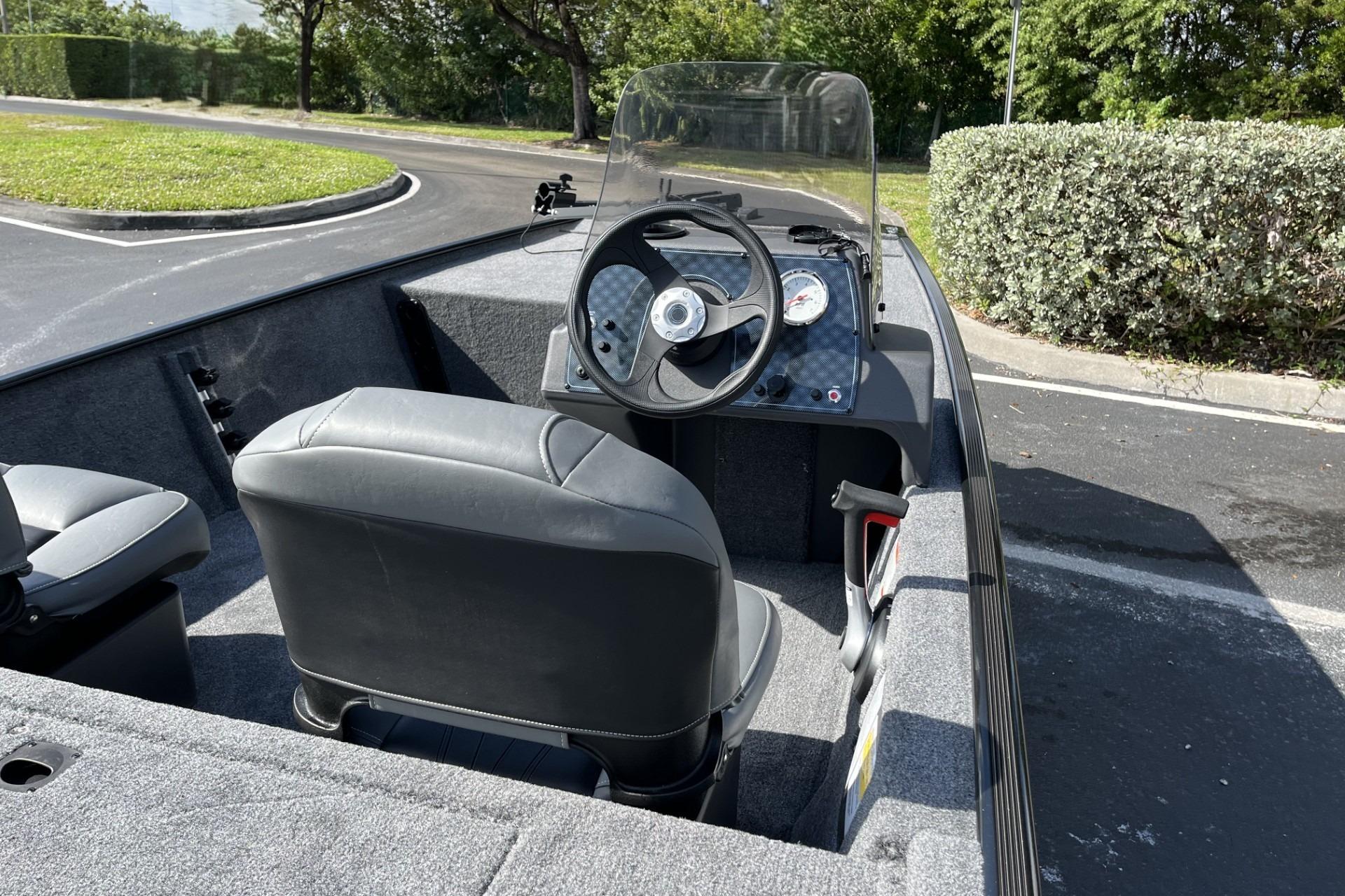 2026 Tracker Bass Tracker Classic XL boat interior with steering wheel and seats.