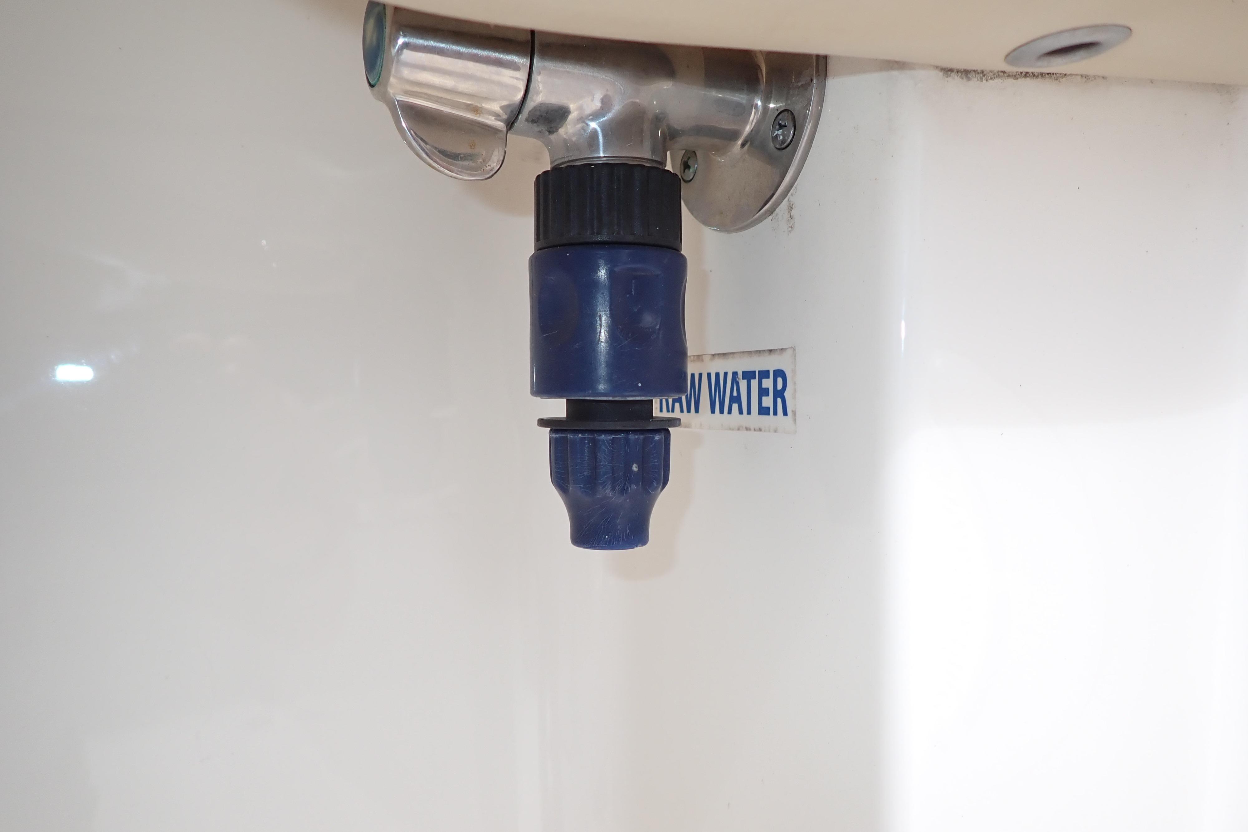 Raw water outlet on 2019 Key West 263 FS boat, featuring a blue nozzle.