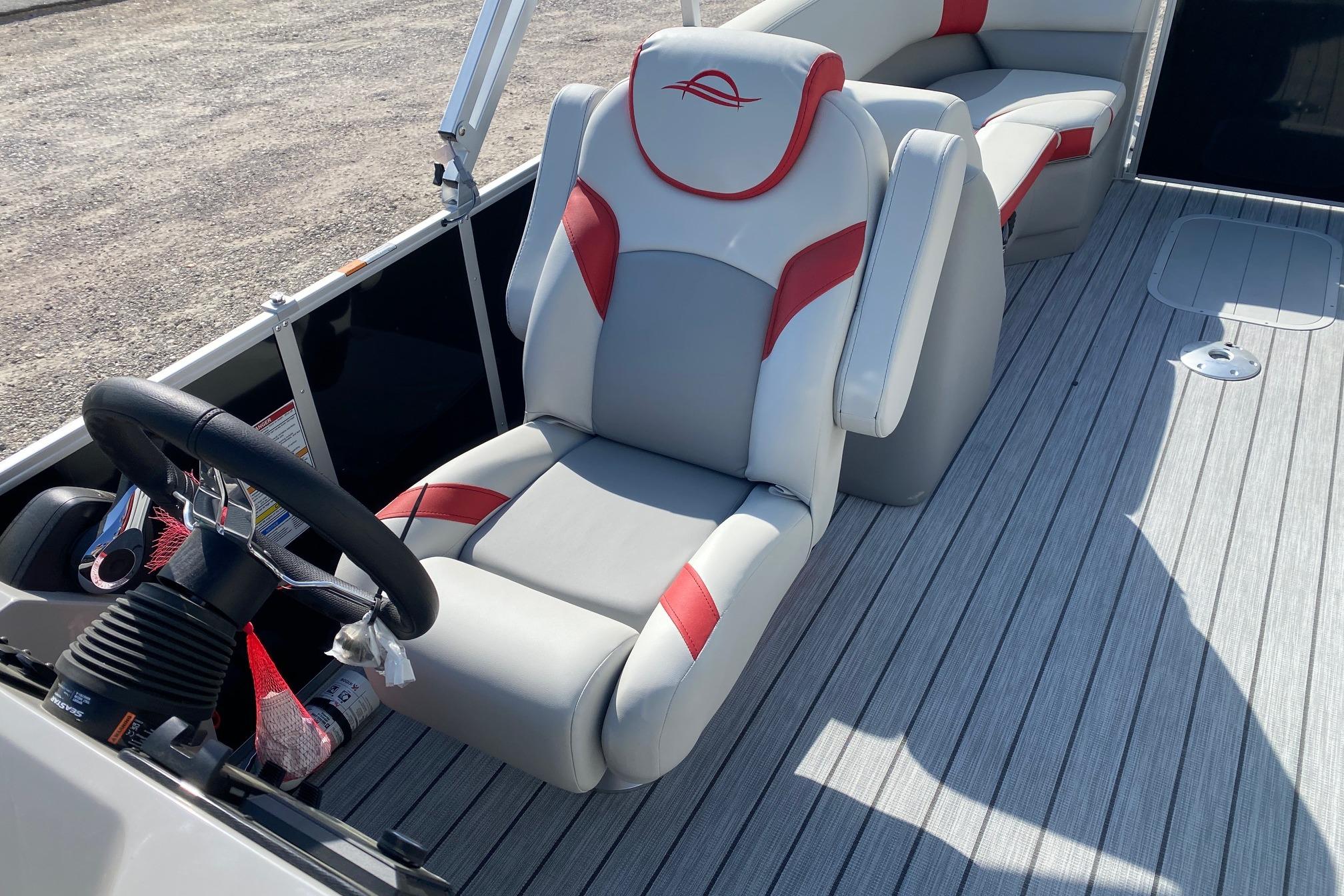 2026 SunCatcher Select 322RC boat interior with steering wheel and cushioned seating.