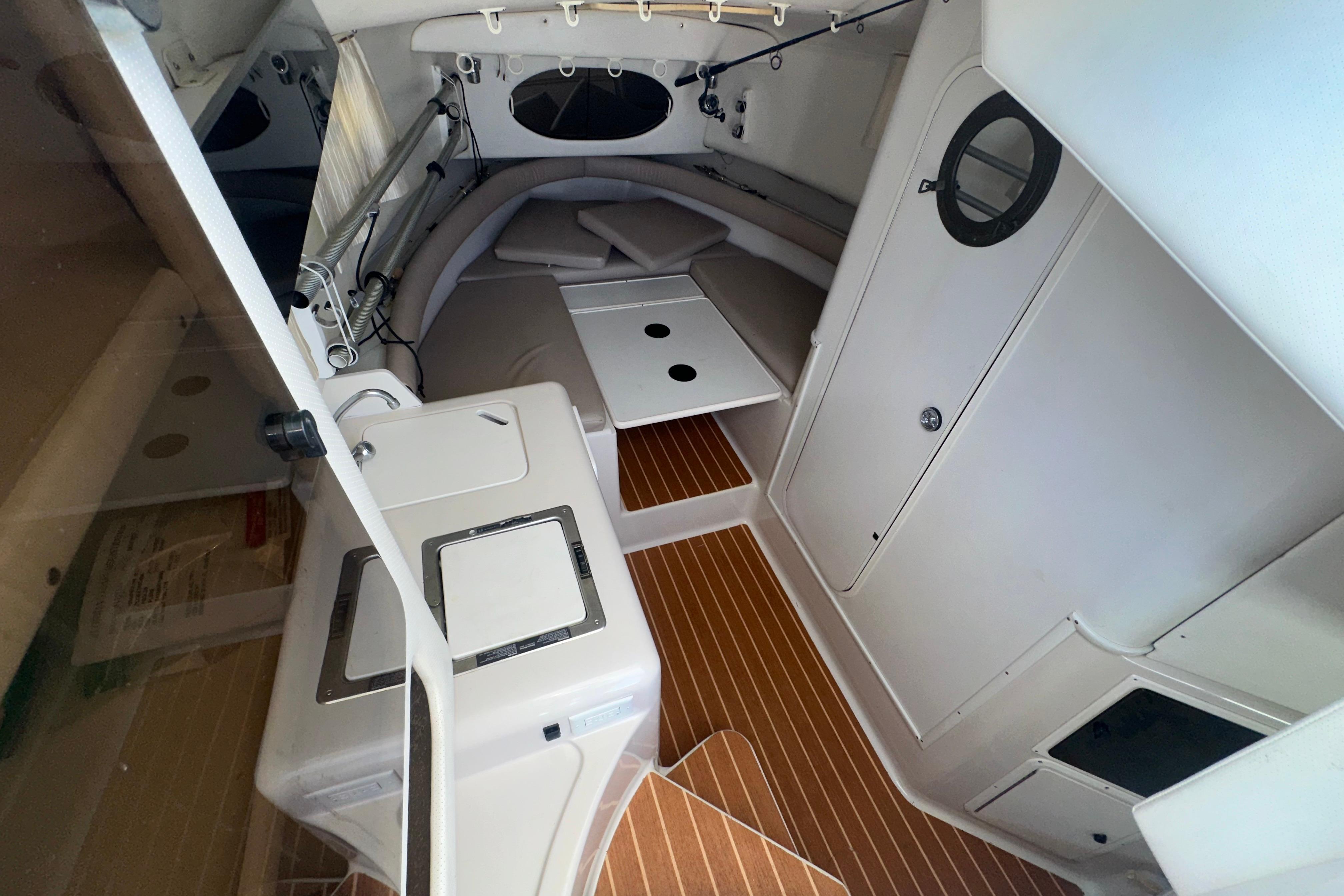1994 Pro-Line 2950 Walkaround cabin interior with wood flooring and compact amenities.