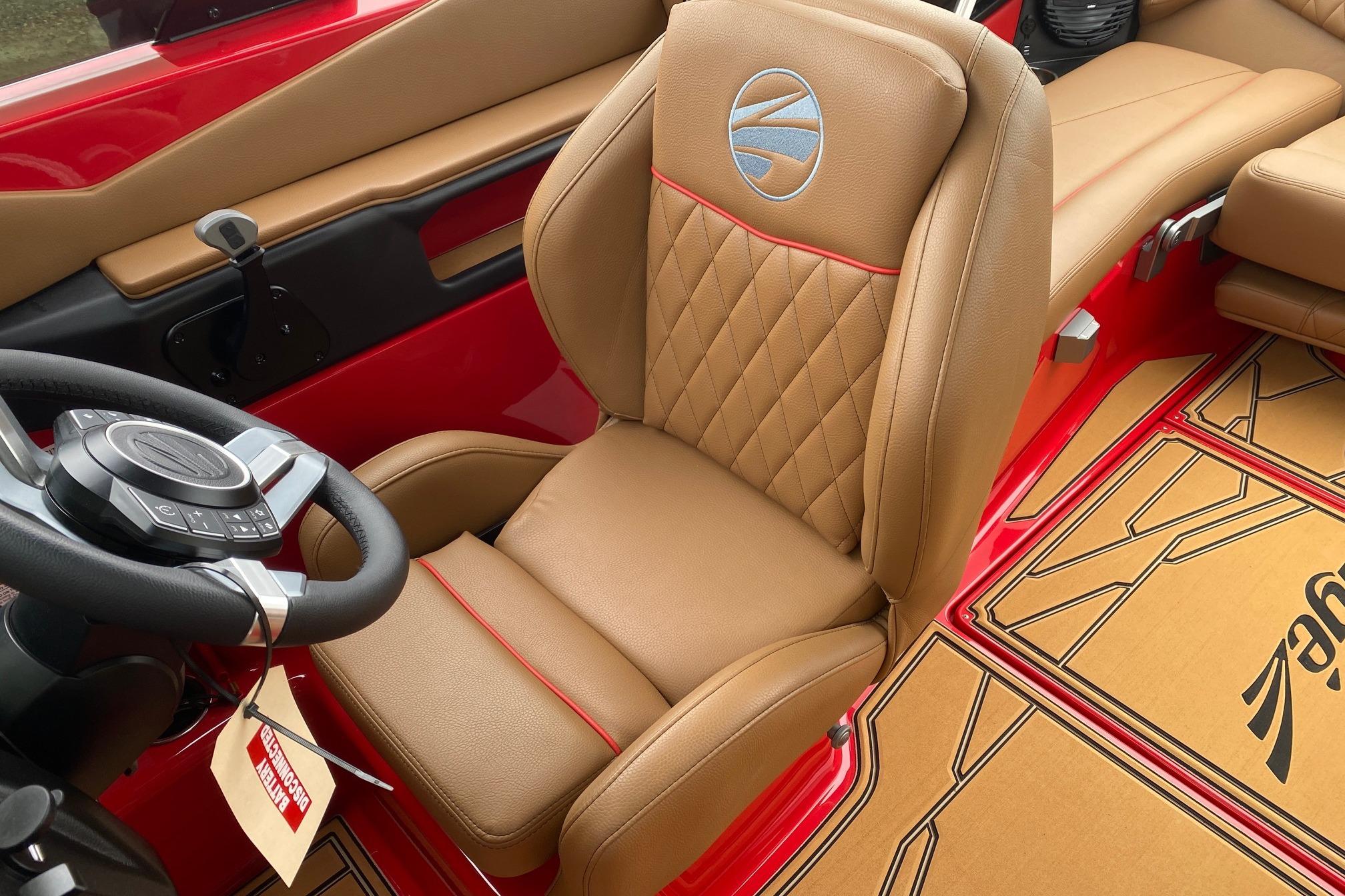 2026 Tigé Z3 boat interior with tan leather seat and red accents.