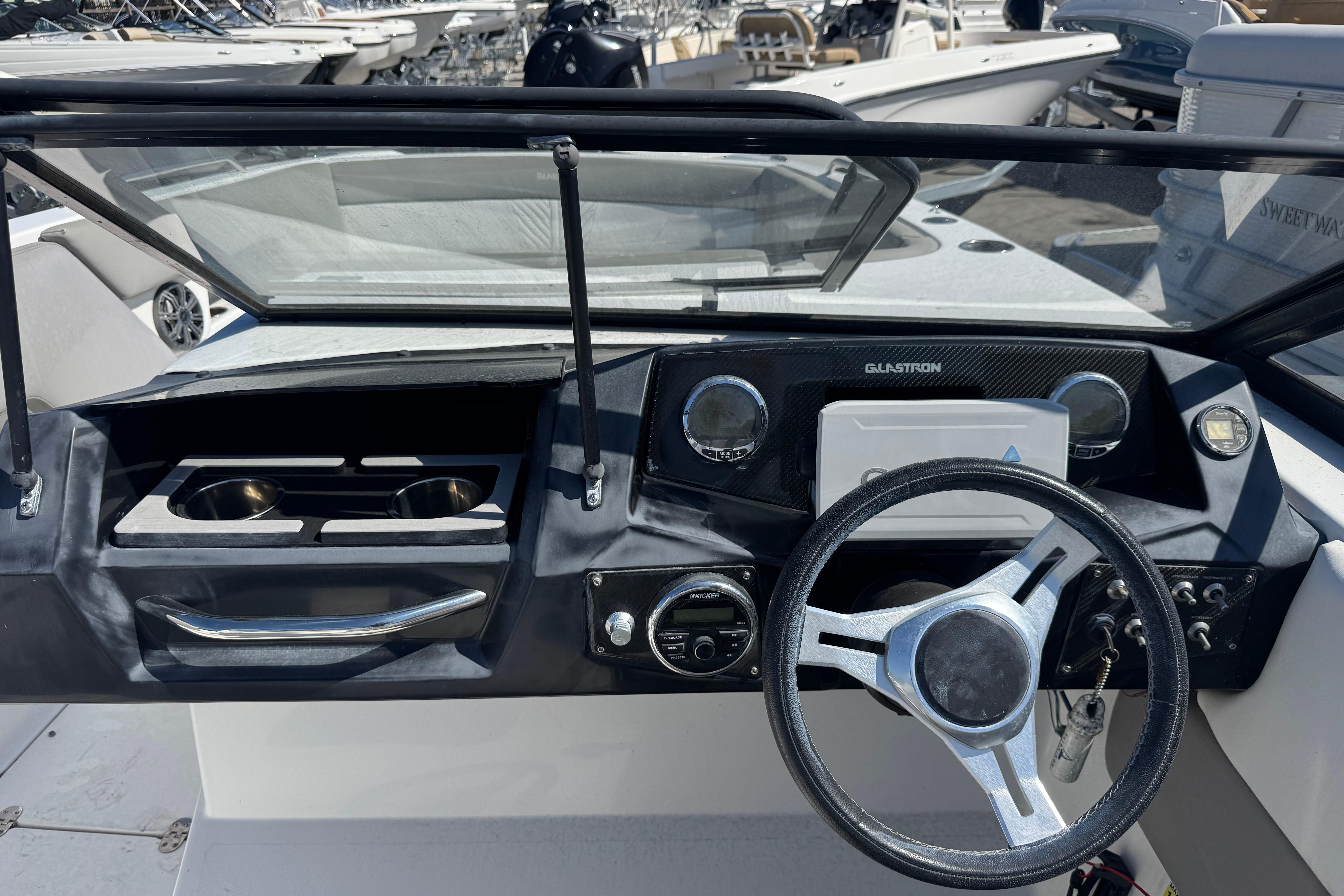2020 Glastron GTD 240 boat dashboard with steering wheel and control panel.