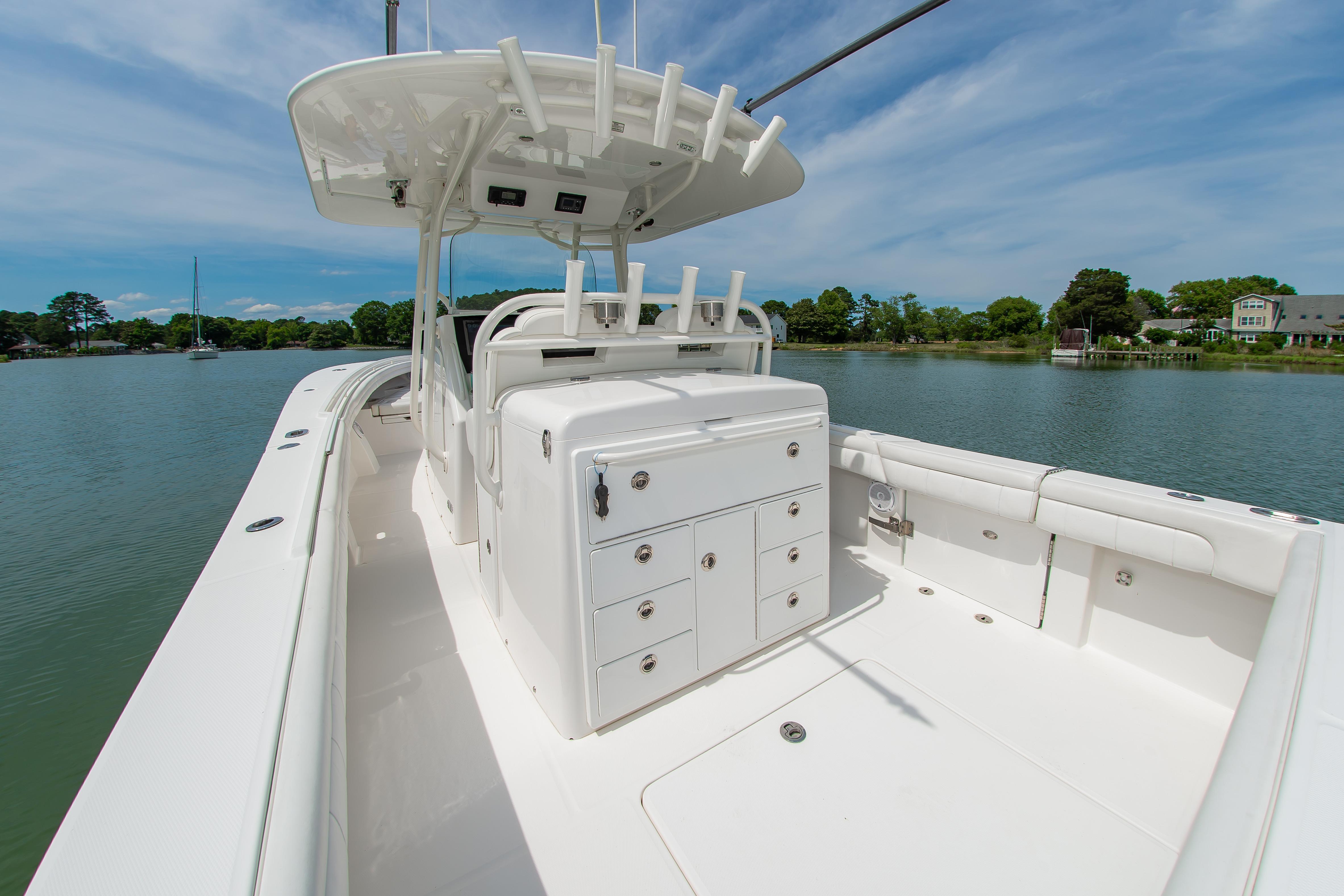 2019 Regulator 31 boat with spacious deck and storage, docked on a serene lake.