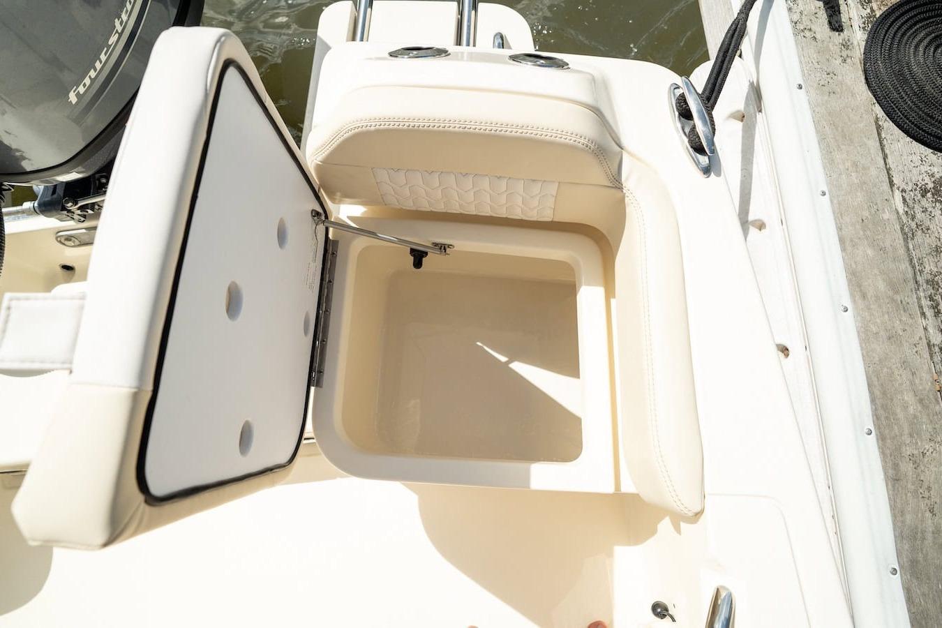 Open storage compartment on 2026 Scout 188 Sportfish boat, showcasing interior design.