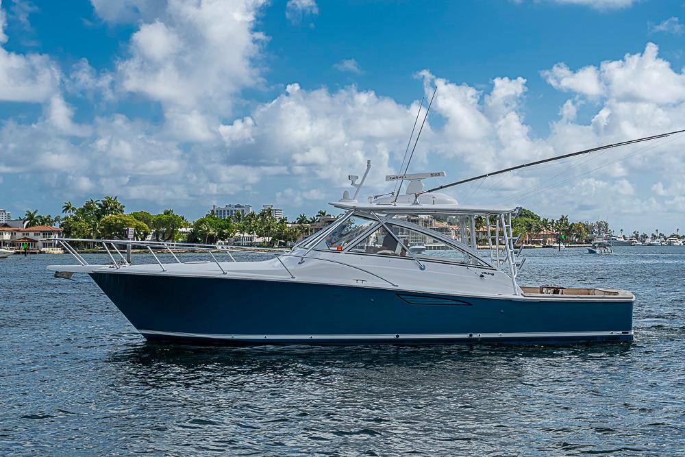 2021 Viking 38 Open yacht on calm water under a blue sky.