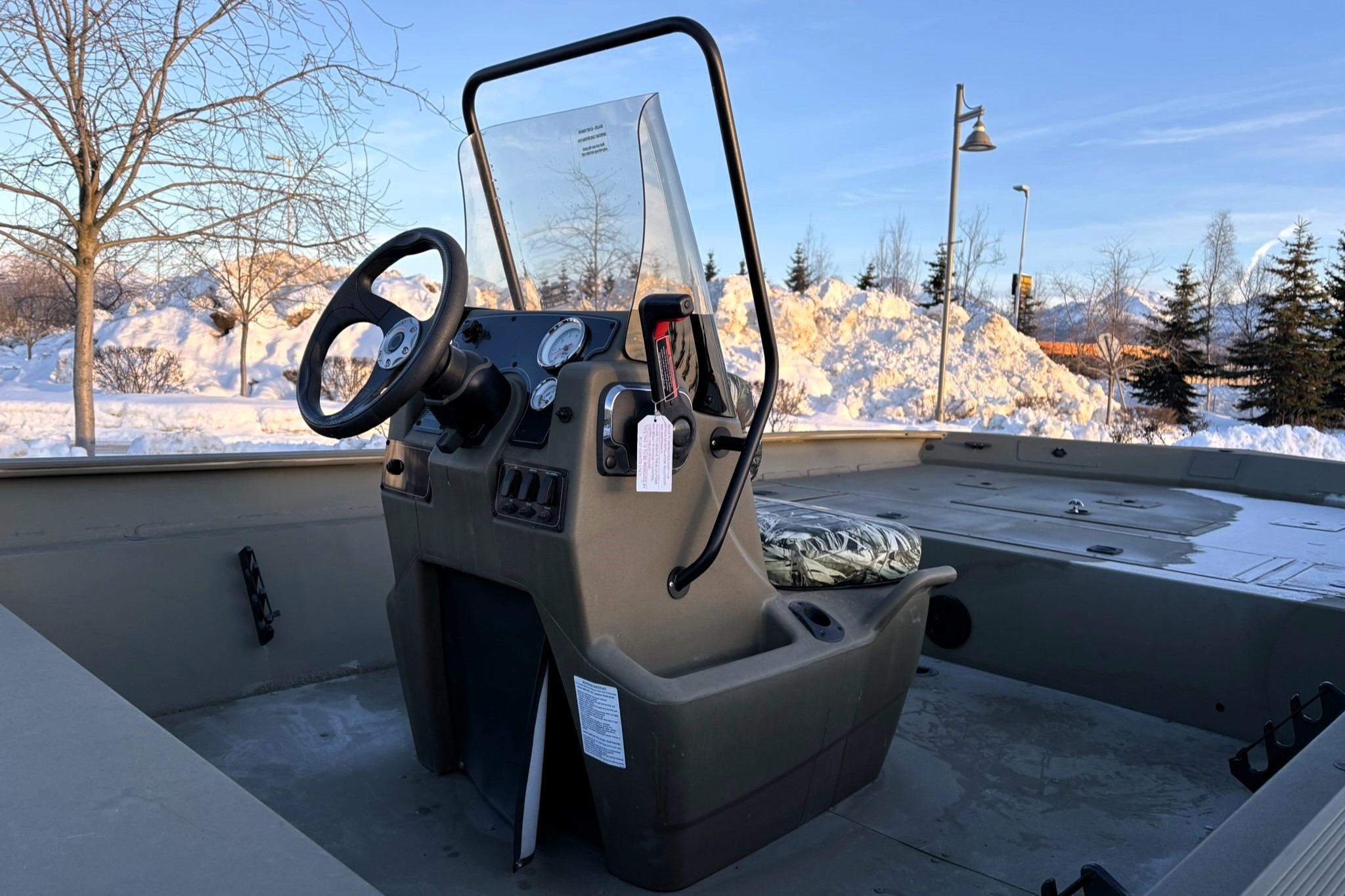 2024 Tracker Grizzly 2072 CC boat console in snowy outdoor setting.