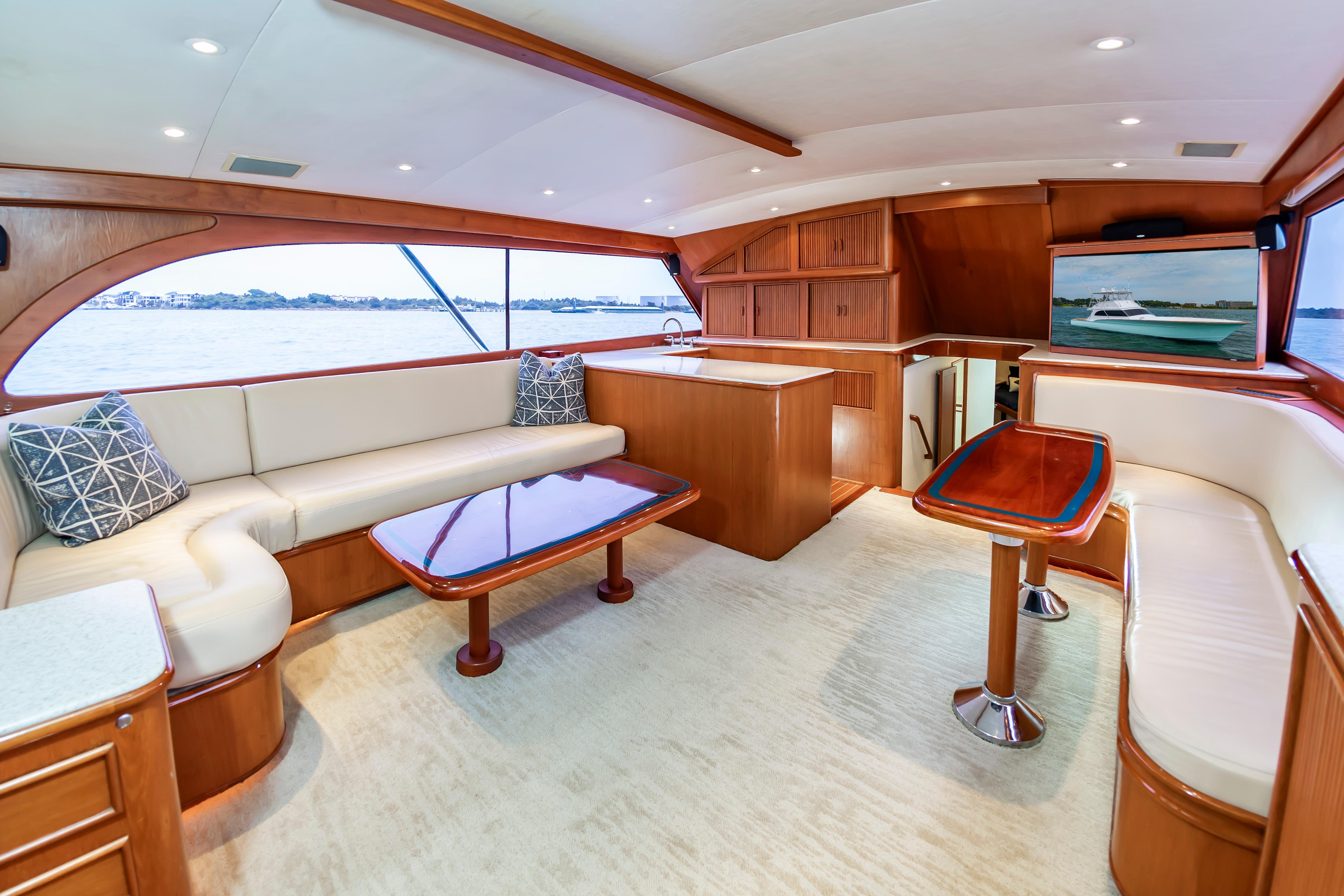 Luxurious interior of 1993 Custom Carolina Scarborough 56 Convertible yacht with elegant wood finishes.