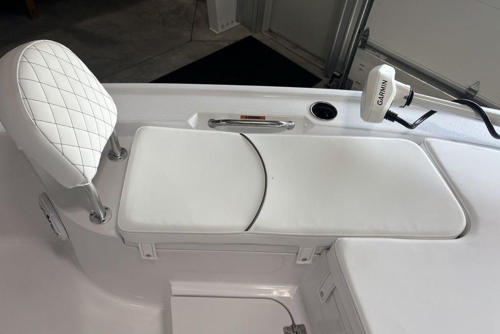 2026 Sportsman Masters 247 Bay Boat interior with white cushioned seating and Garmin device.