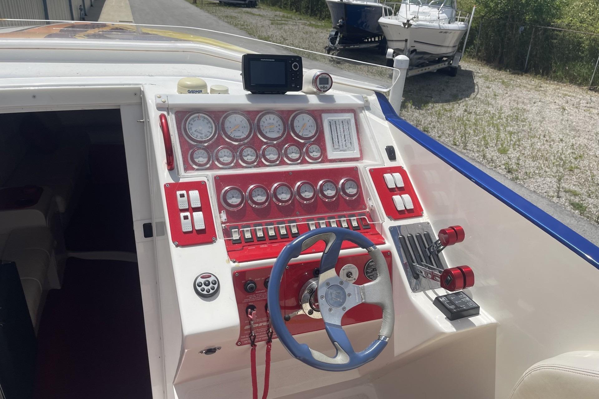 Cockpit of a 2006 Sonic 386 boat with red and white dashboard controls.