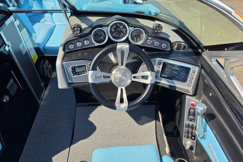 2017 MasterCraft X23 boat dashboard with steering wheel, gauges, and control panel.