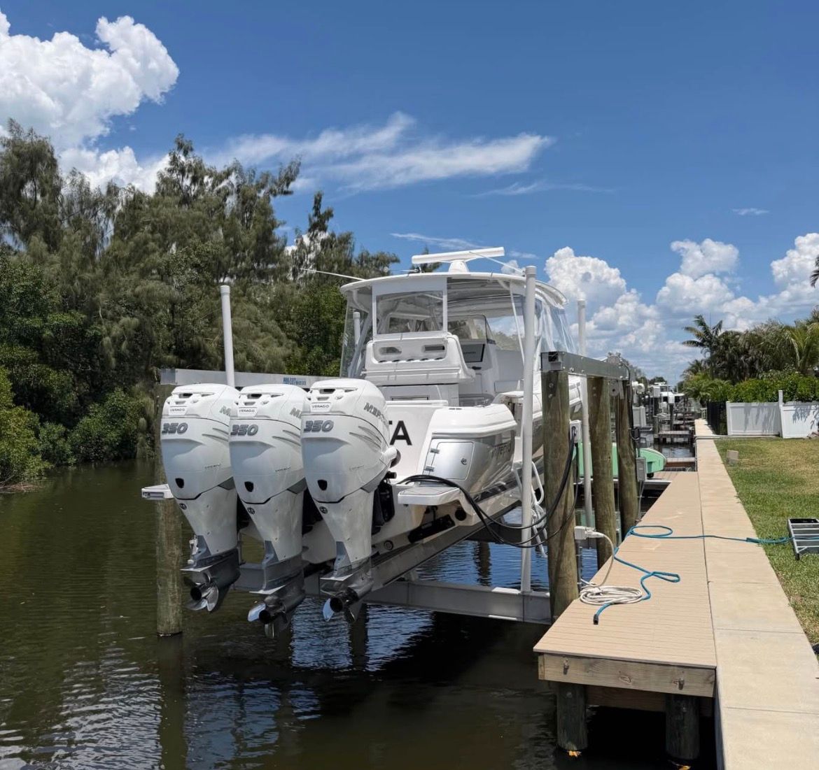 2018 Intrepid 375 boat with triple outboard engines at dock.