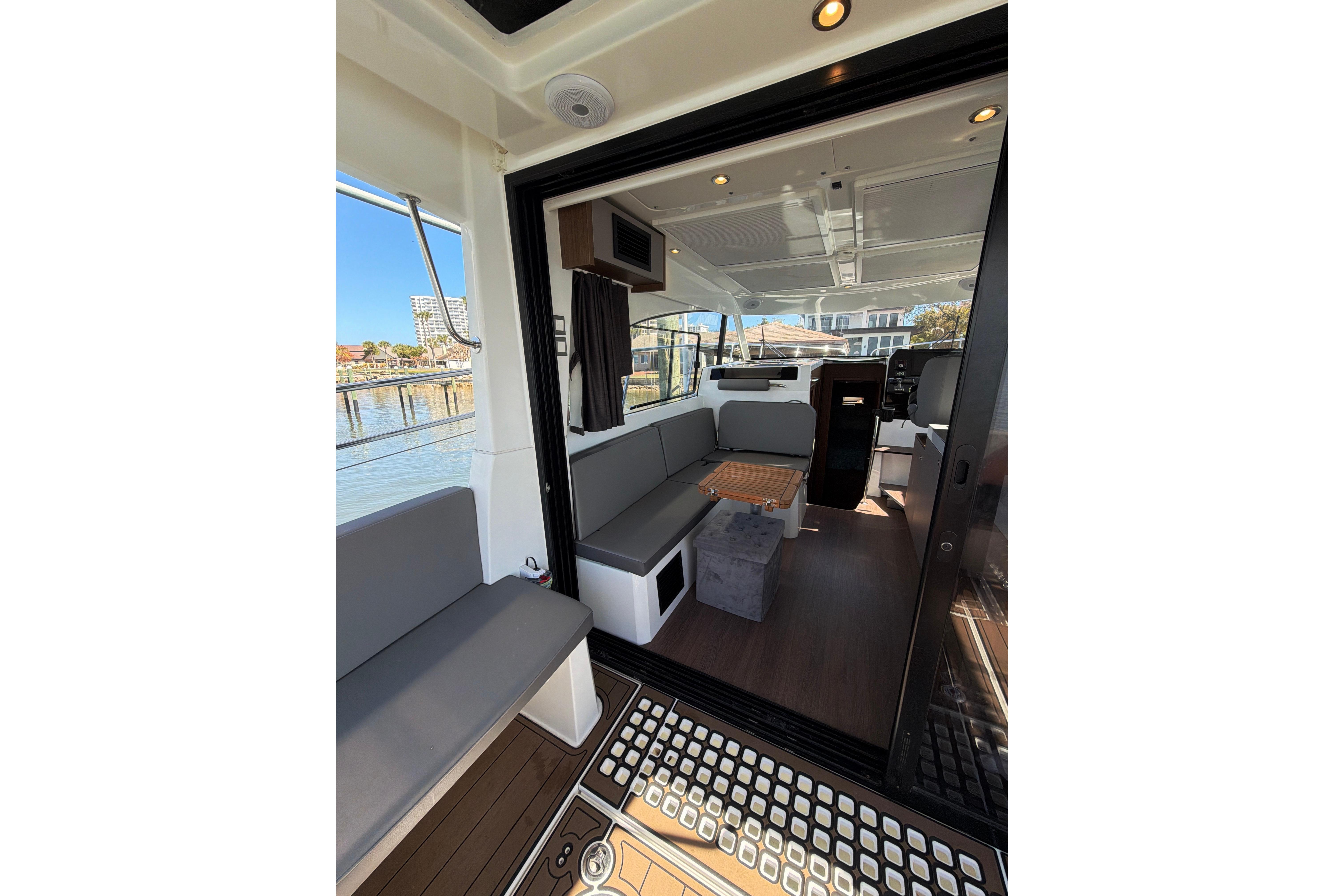Interior view of 2023 Beneteau Antares 11 boat, featuring modern seating and sleek design.