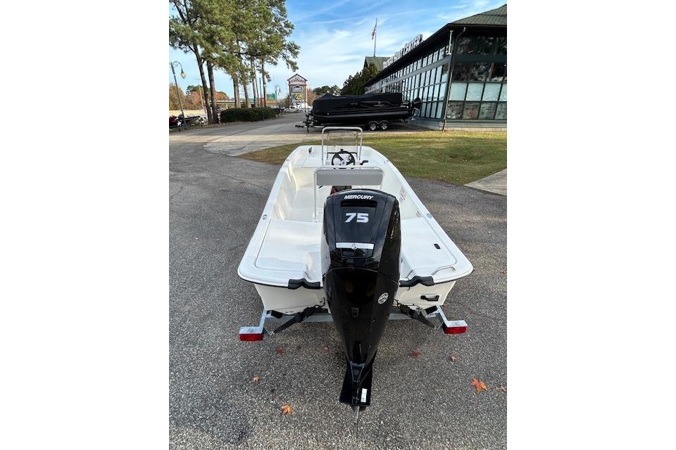 2025 Mako Pro Skiff 17 CC with Mercury 75 engine, parked outdoors.