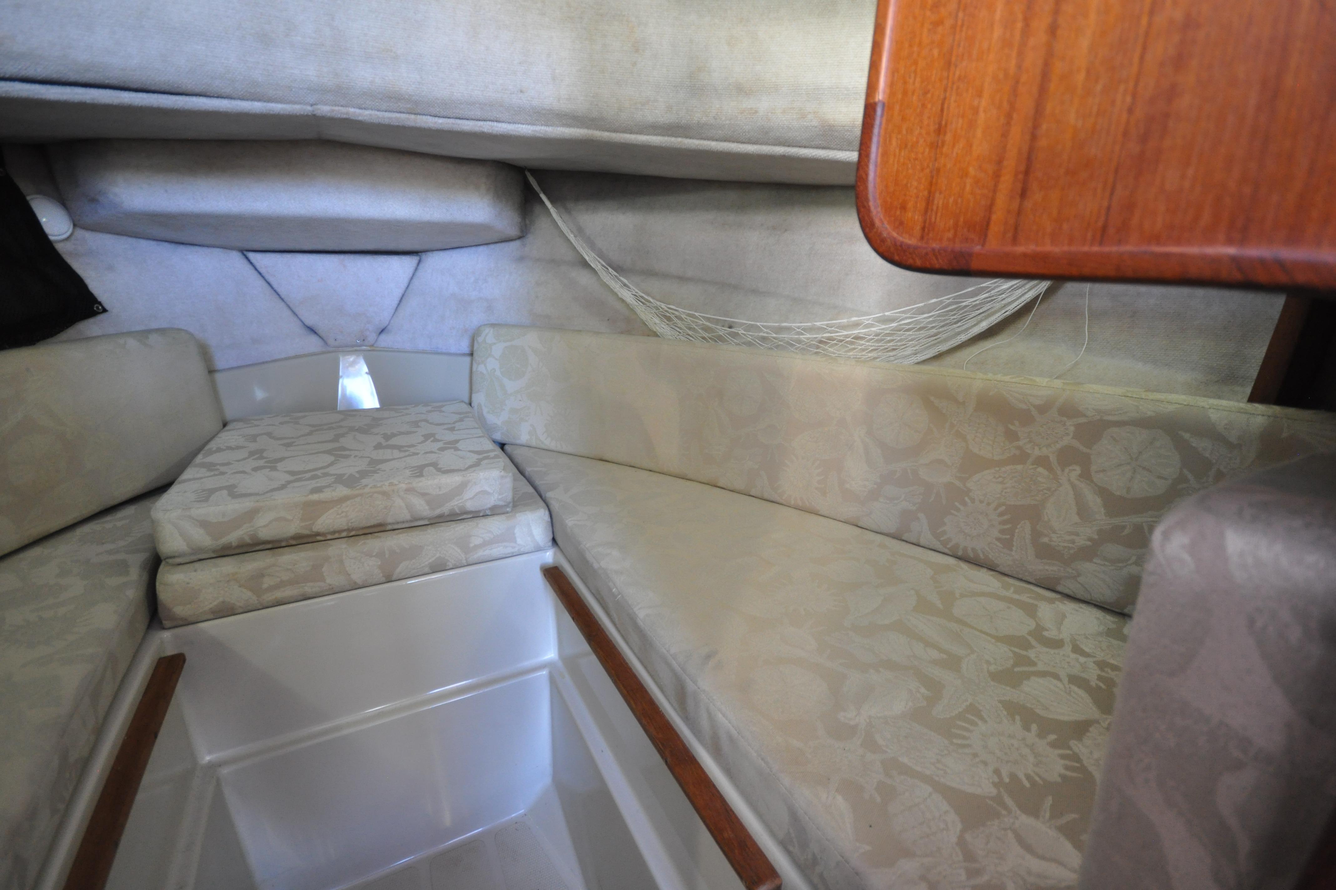 Interior cabin of 2007 Ranger Tug R-25 with cushioned seating and wooden accents.