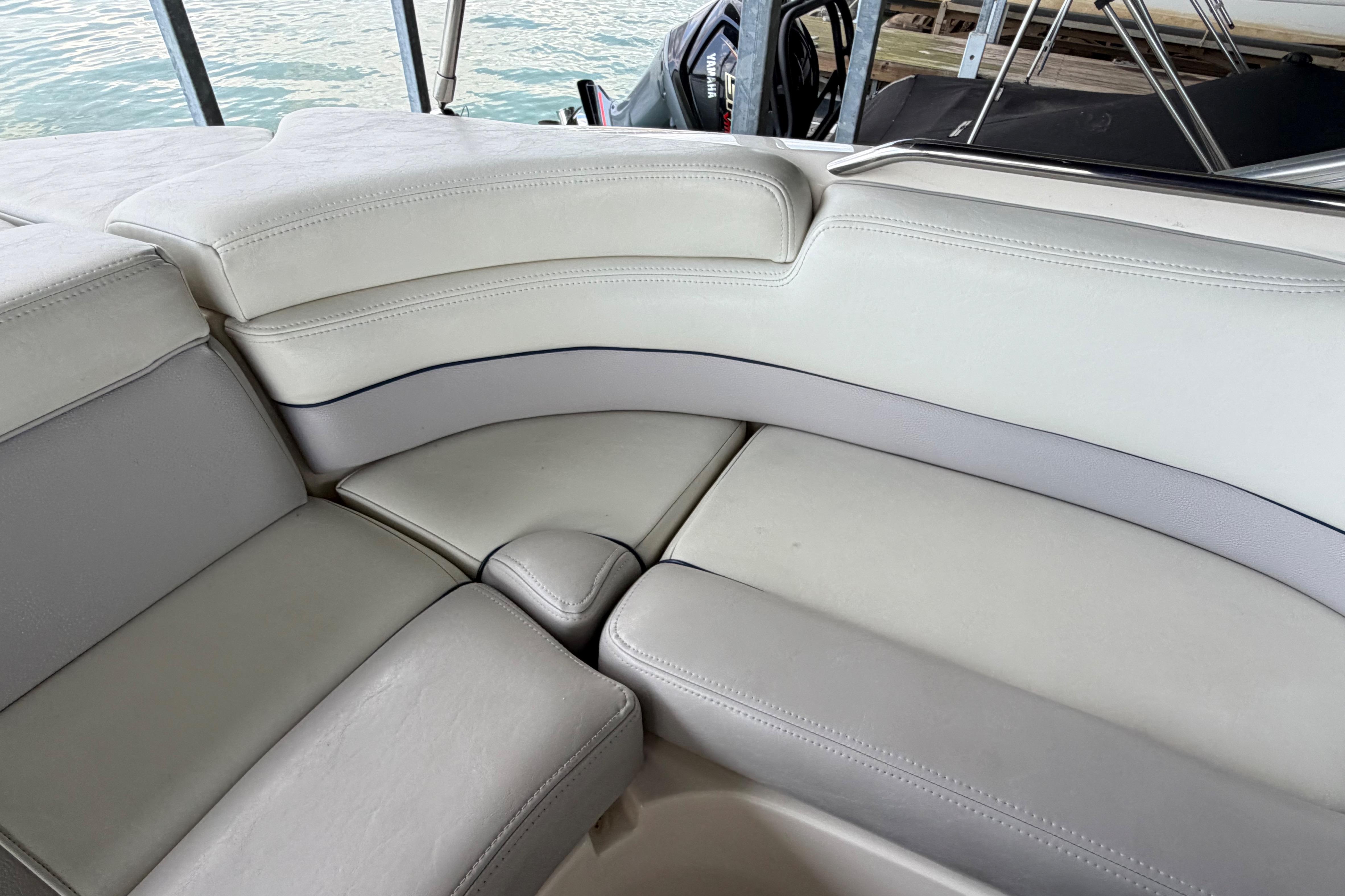 Luxurious seating on a 2010 Bryant 255 boat, featuring white leather upholstery.