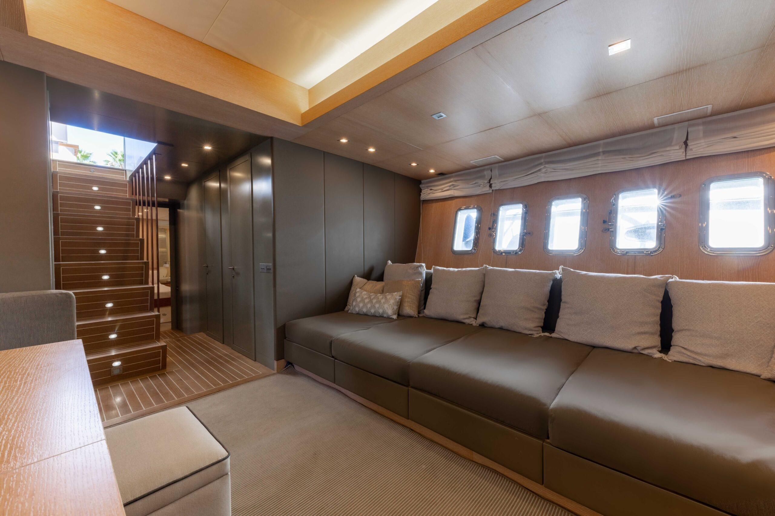 Luxurious interior of 2006 Mangusta 80 yacht with plush seating and elegant lighting.