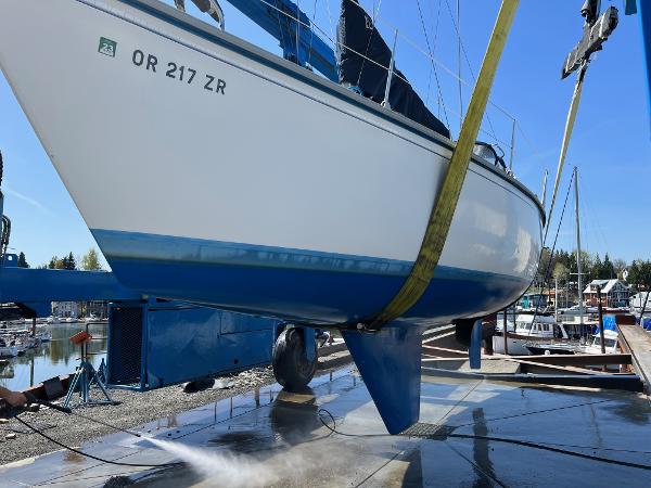 1984 Hunter 31 sailboat being cleaned at a marina.
