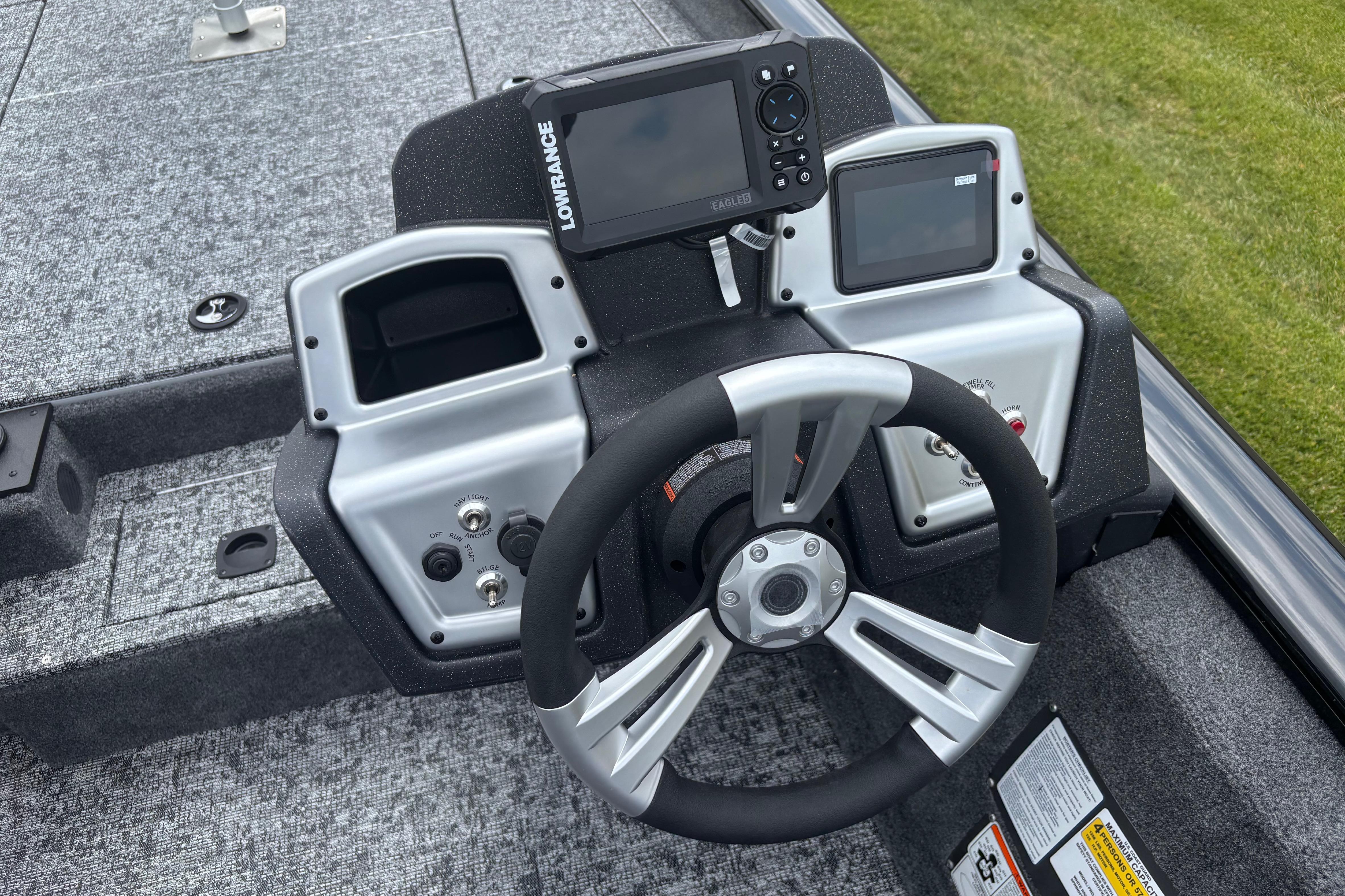 2026 Tracker Pro Team 190 boat dashboard with steering wheel and electronic displays.