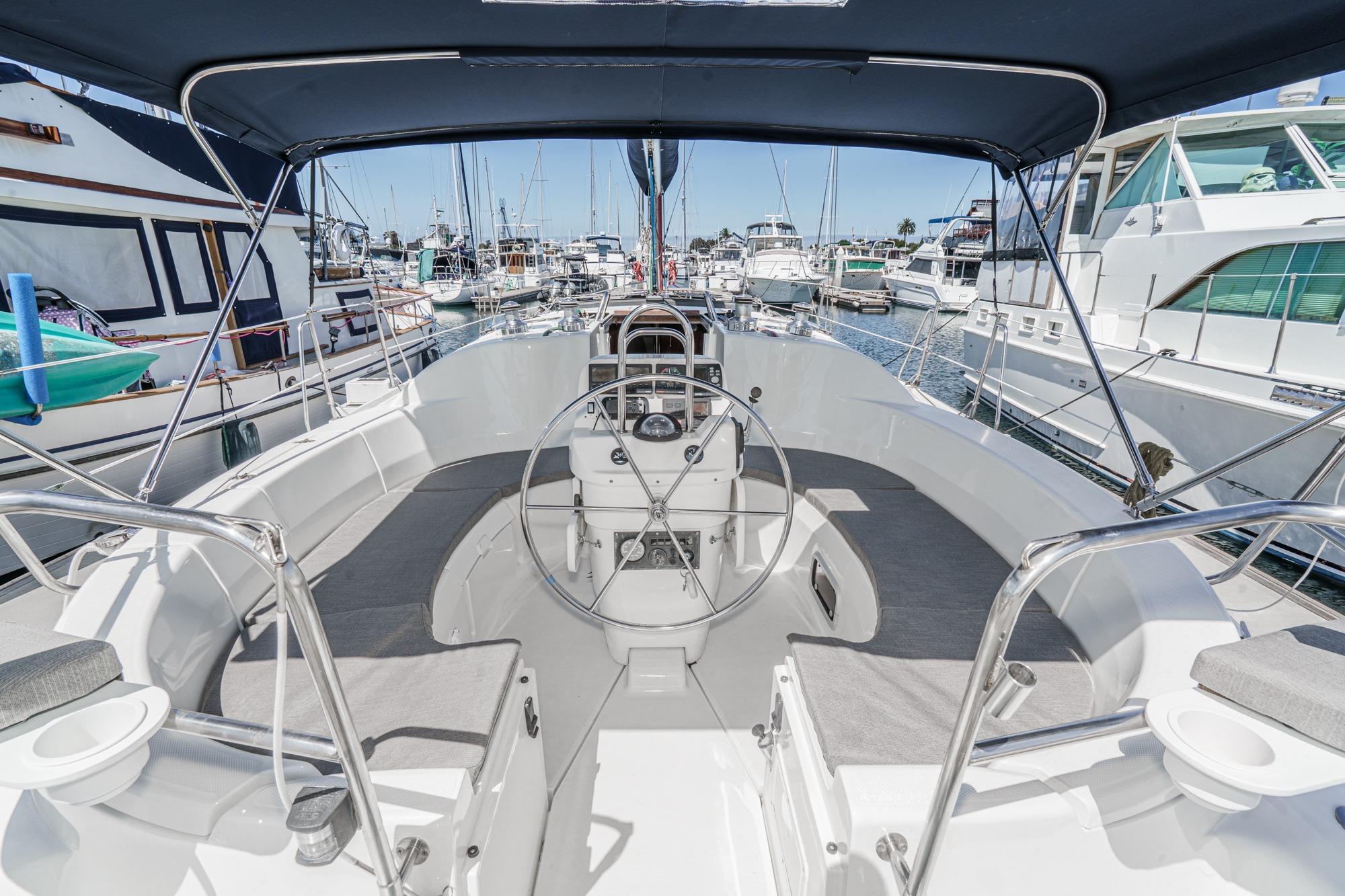 Cockpit view of a 1996 Hunter 376 sailboat docked in a marina.