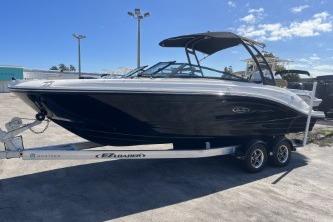 2024 Sea Ray SPX 230 boat on trailer, sleek black design under clear blue sky.