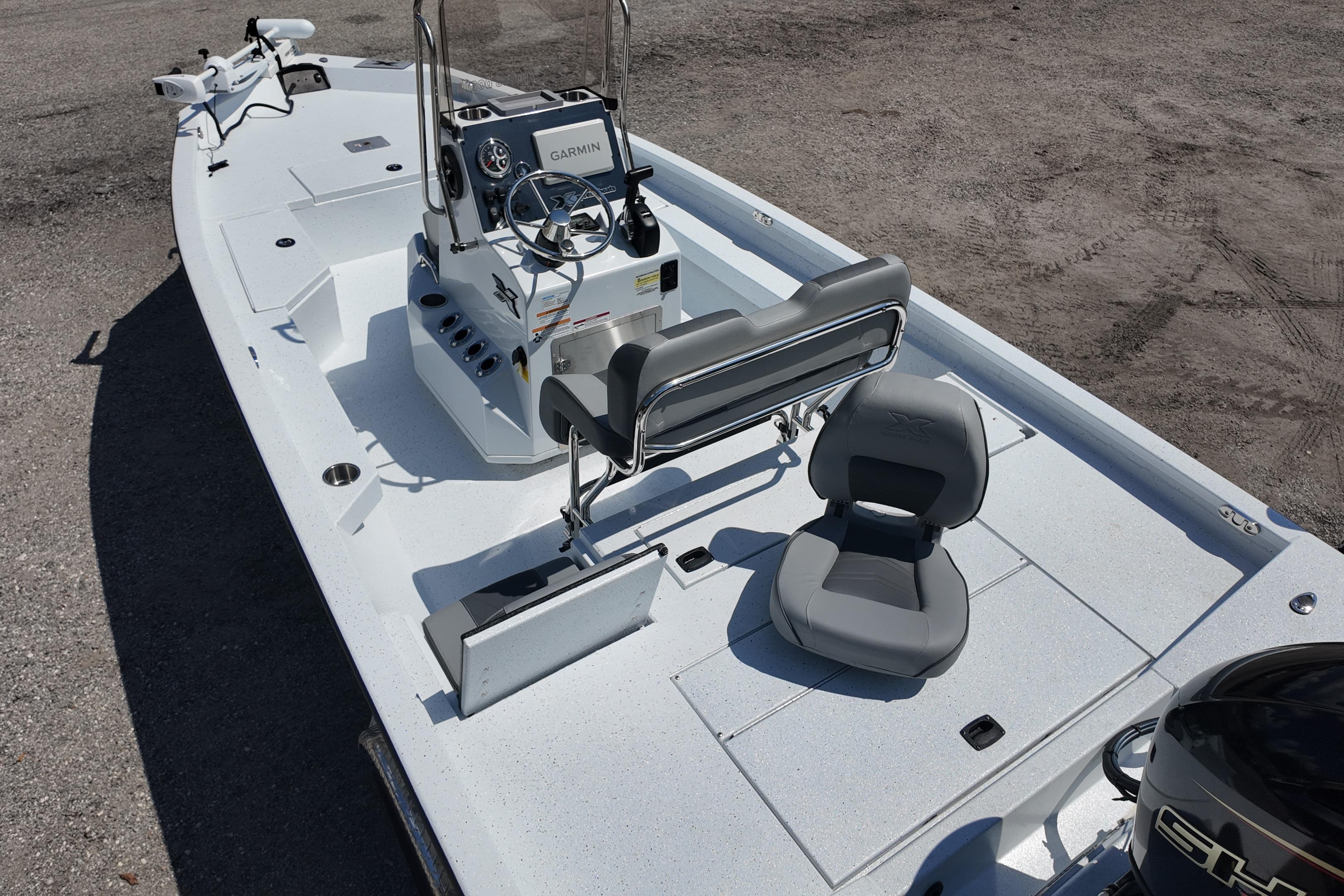 2026 Xpress H20 boat interior with Garmin system, gray seating, and steering console.