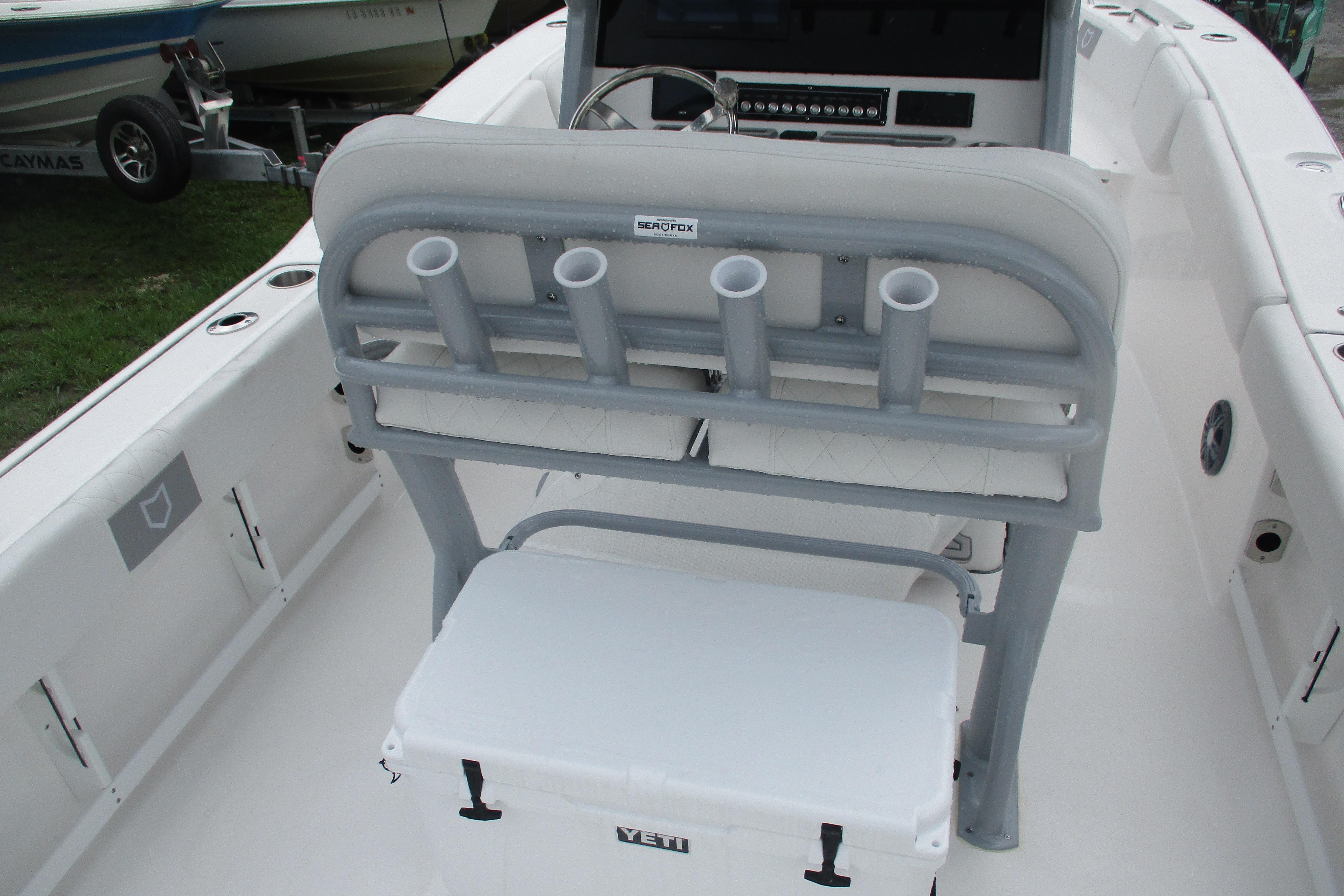 2026 Sea Fox 248 Commander boat interior with rod holders and Yeti cooler.