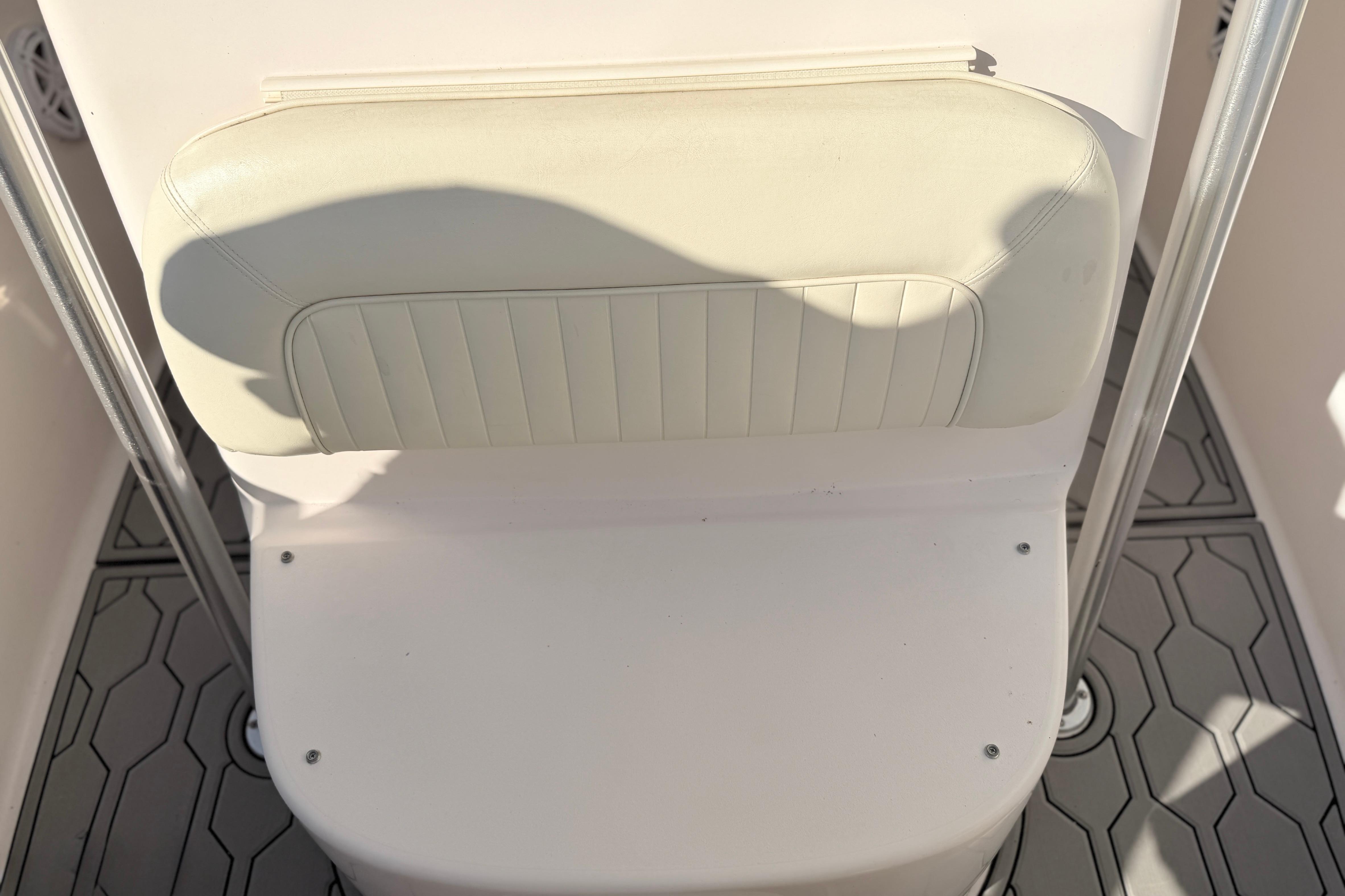 2004 Grady White 273 boat seat with white cushion and metal frame.