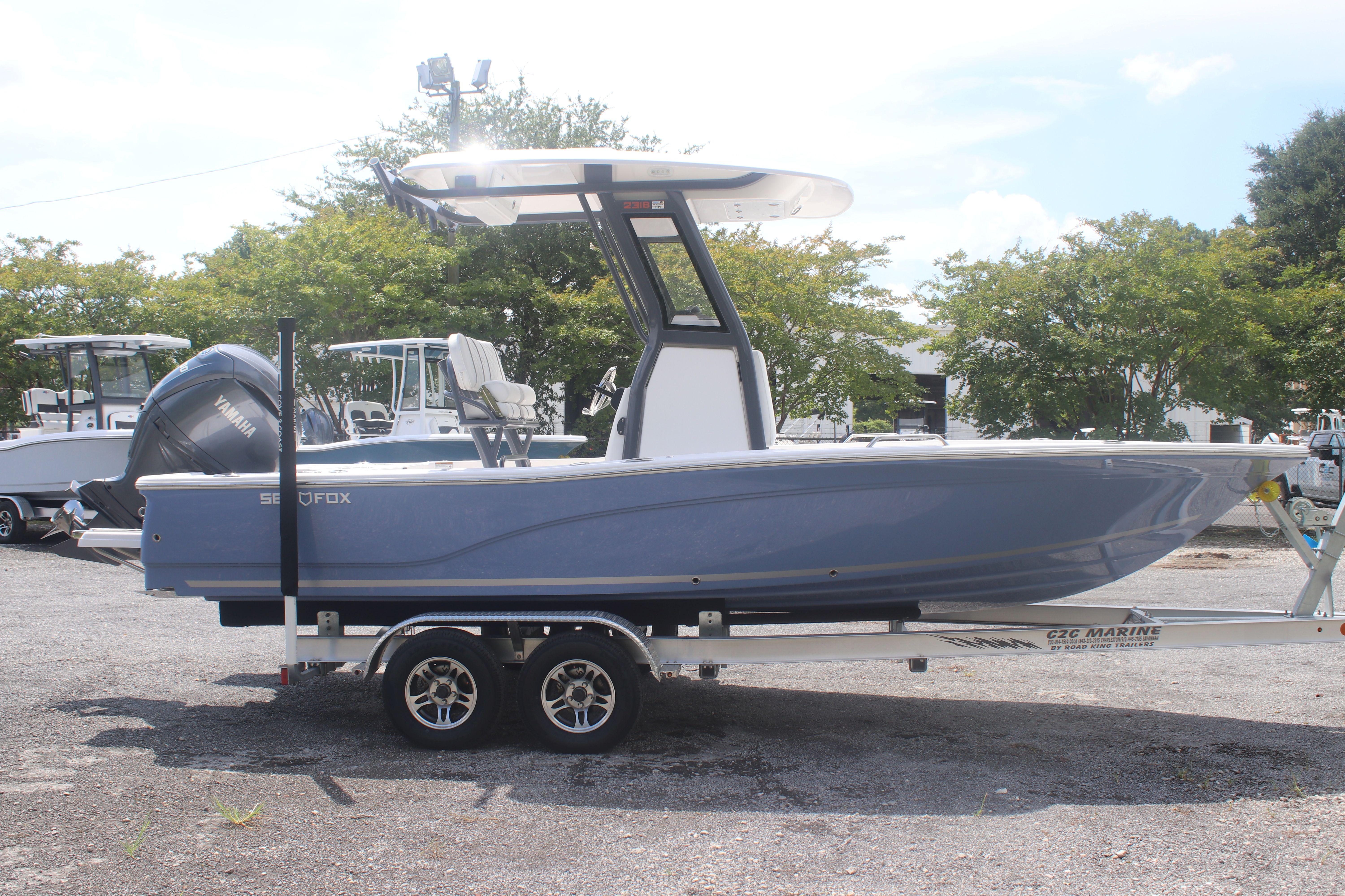 2025 Sea Fox 231 Bay Fox boat on trailer, side view, outdoors.