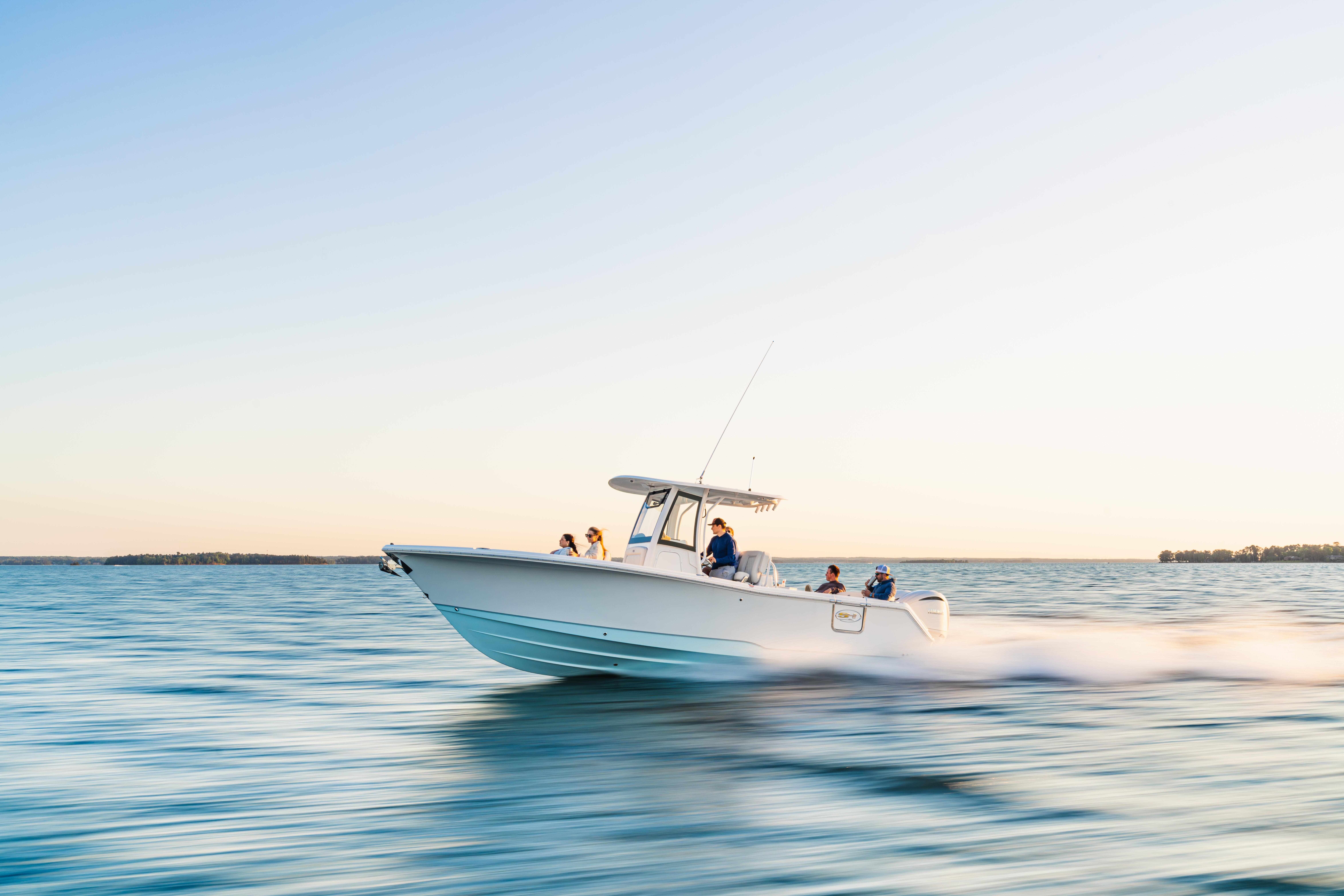 2027 Sea Hunt Ultra 275 SE cruising on open water at sunset.