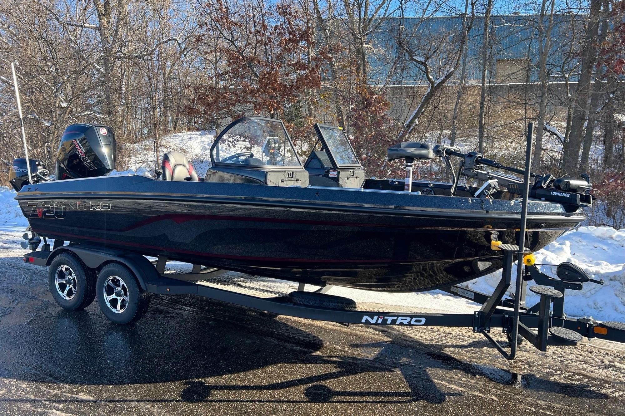 2026 Nitro ZV20 boat on trailer, parked on snowy road with trees in background.