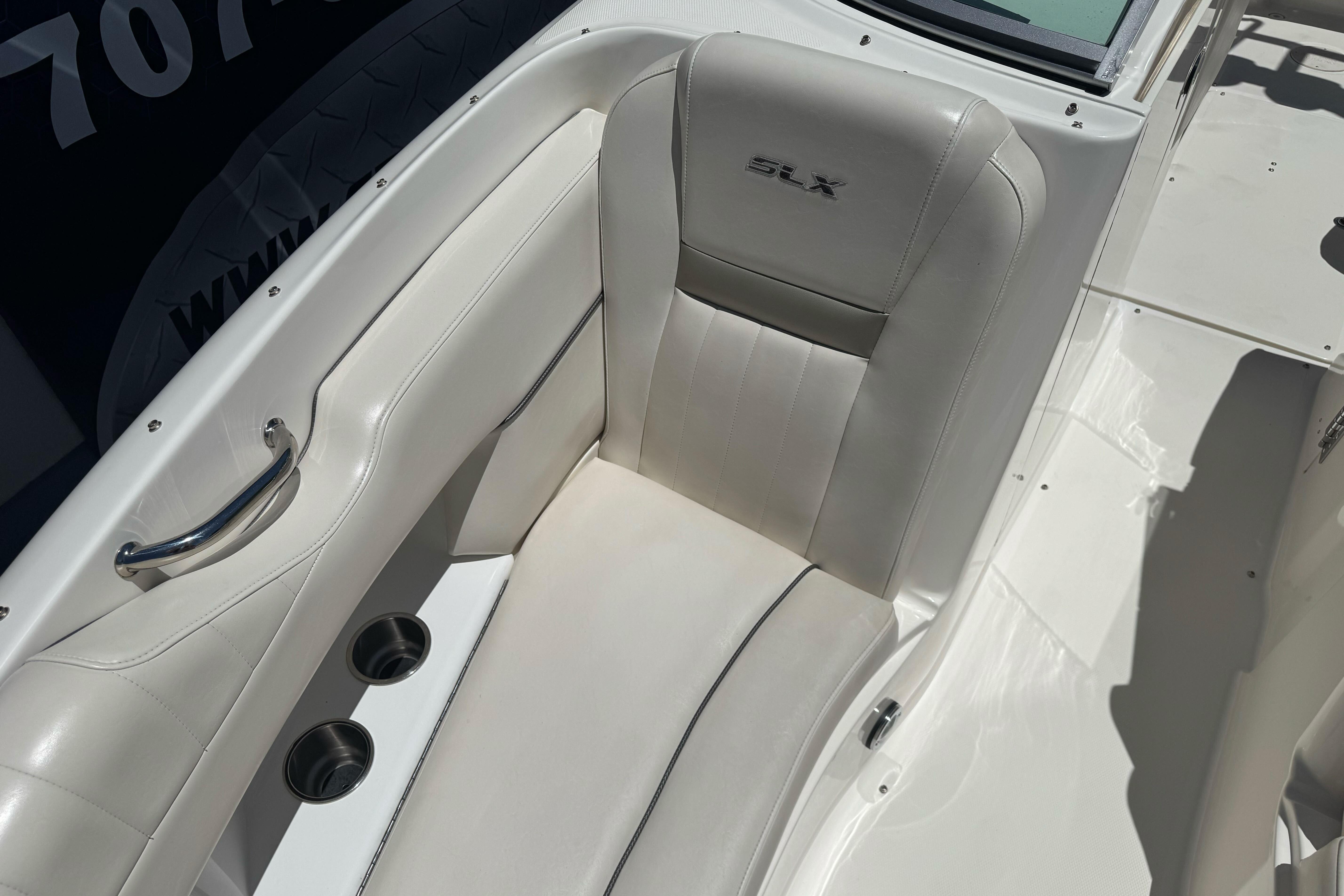 2007 Sea Ray SLX 250 boat interior with white leather seating and cup holders.