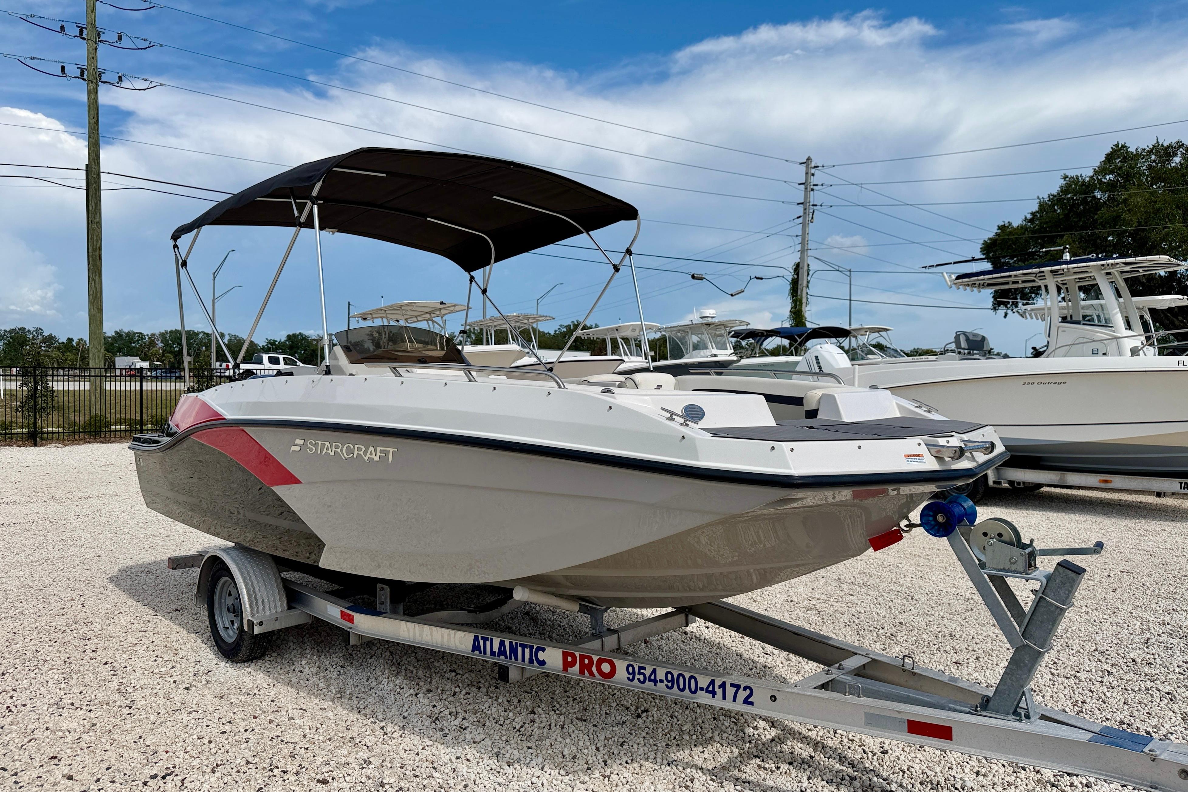 2021 Starcraft SVX 191 OB boat on trailer, featuring a sleek design and canopy.