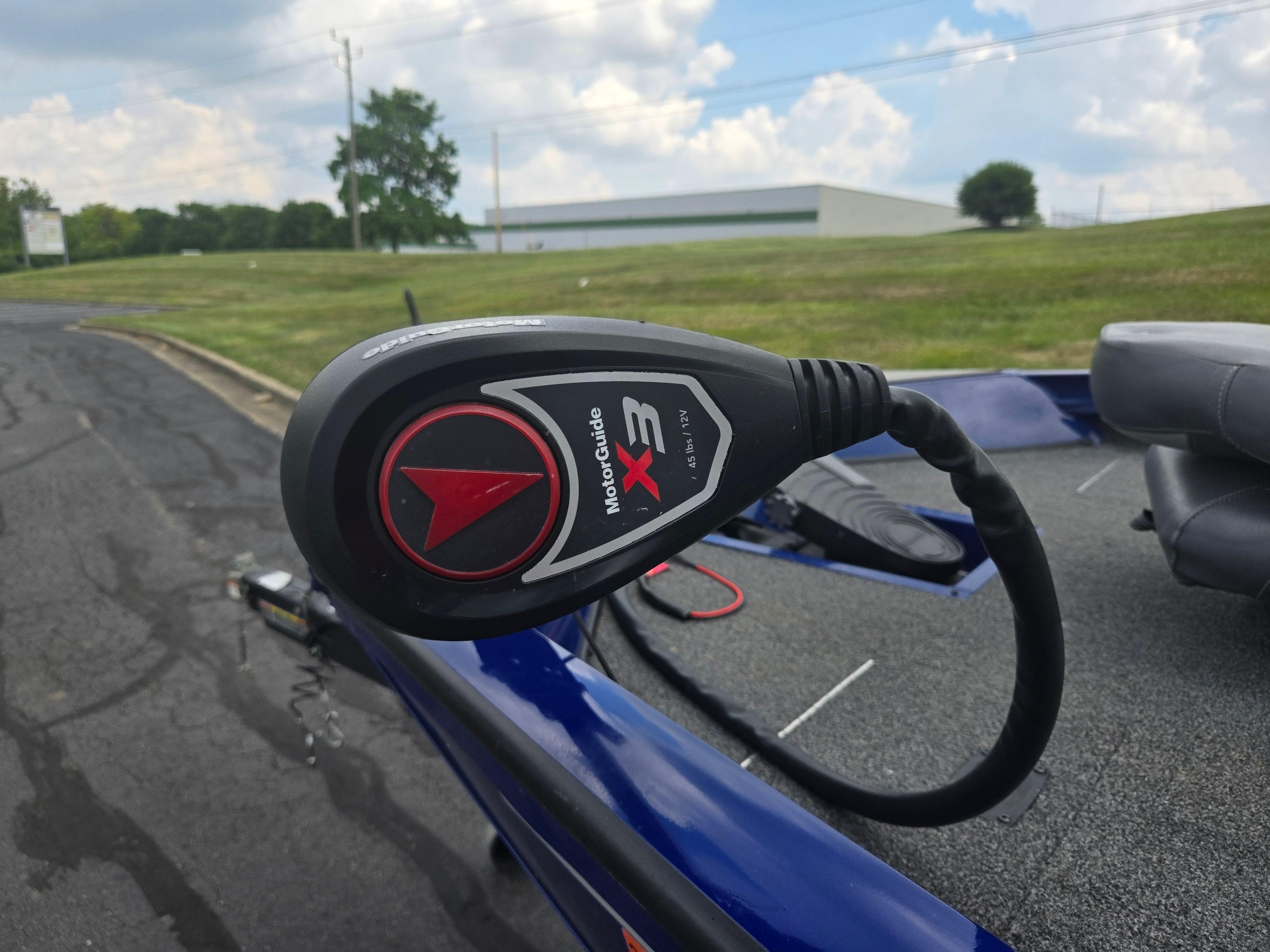 MotorGuide X3 trolling motor on 2021 Lowe Stinger 188 boat, parked on asphalt.