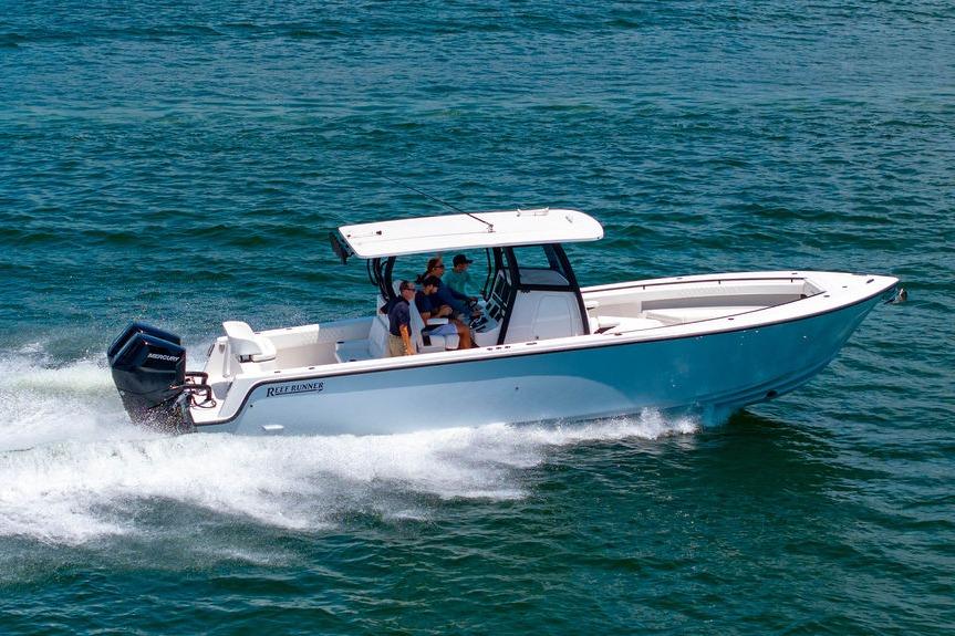 2027 Reef Runner 340 boat cruising on open water with passengers onboard.