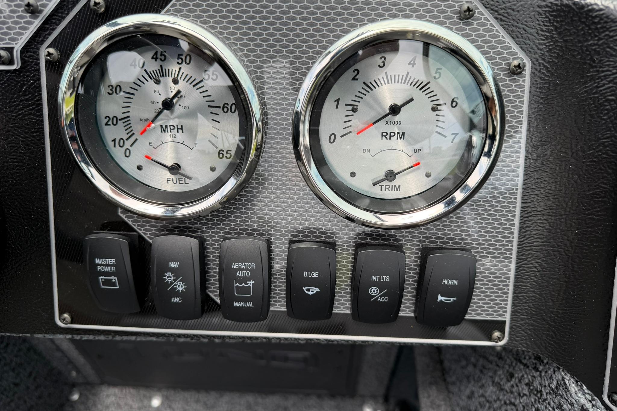 Dashboard of 2027 Lund 1675 Adventure Sport with gauges and control switches.