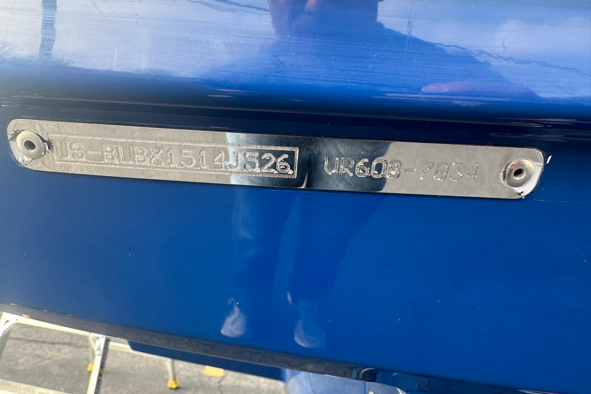 2026 Bayliner VR6 Bowrider OB boat identification plate on blue hull.
