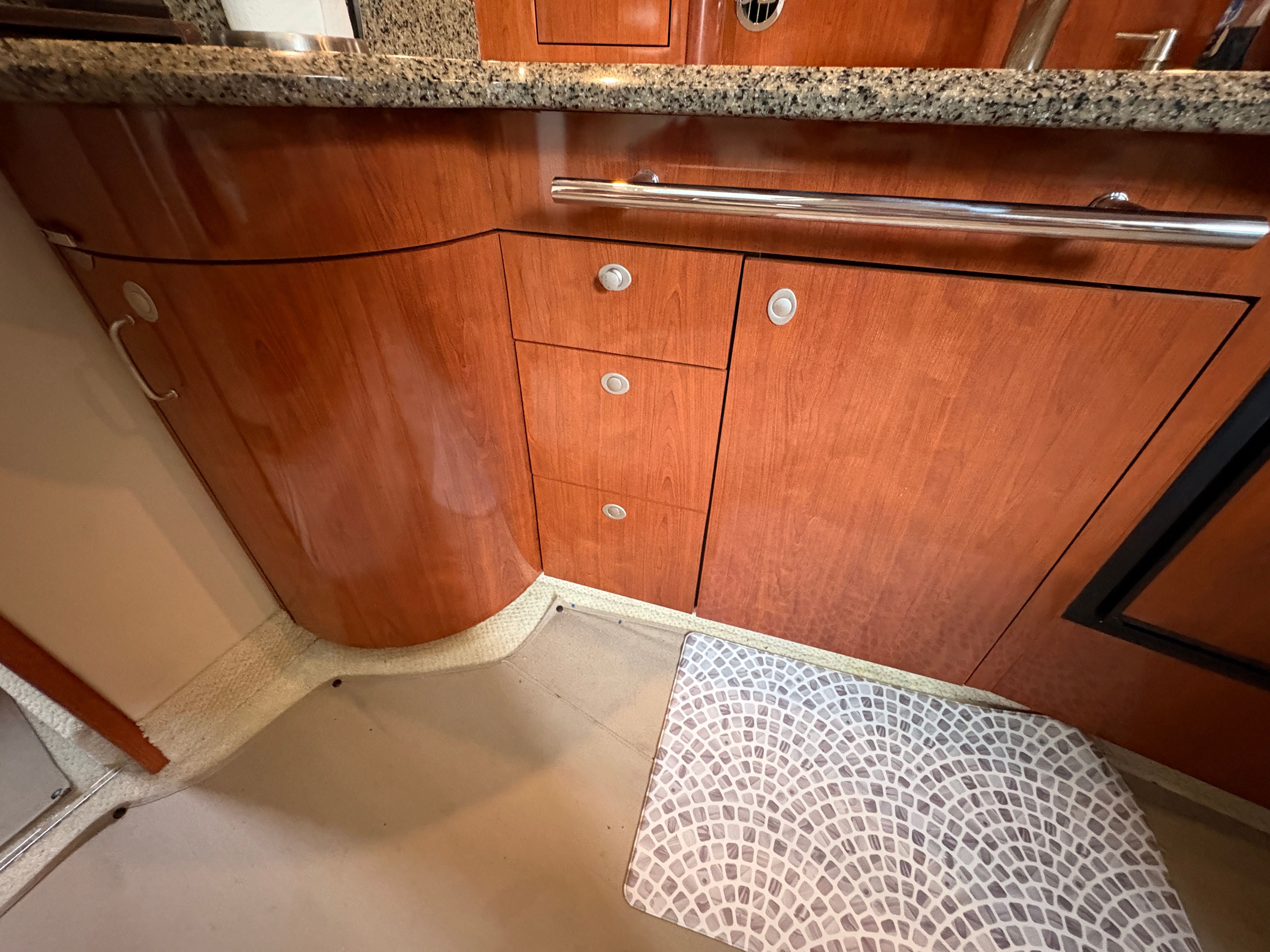 Sea Ray 420 Sundancer 2005 kitchen area with wooden cabinets.