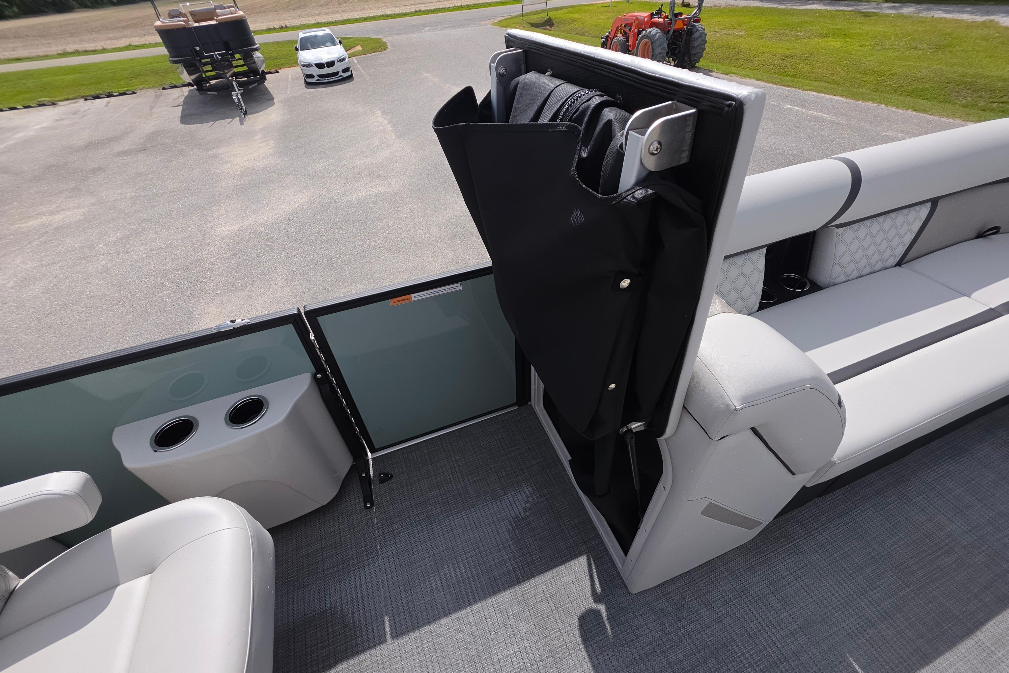 2026 Crest 235 Conquest SLC boat interior with seating and storage compartment.