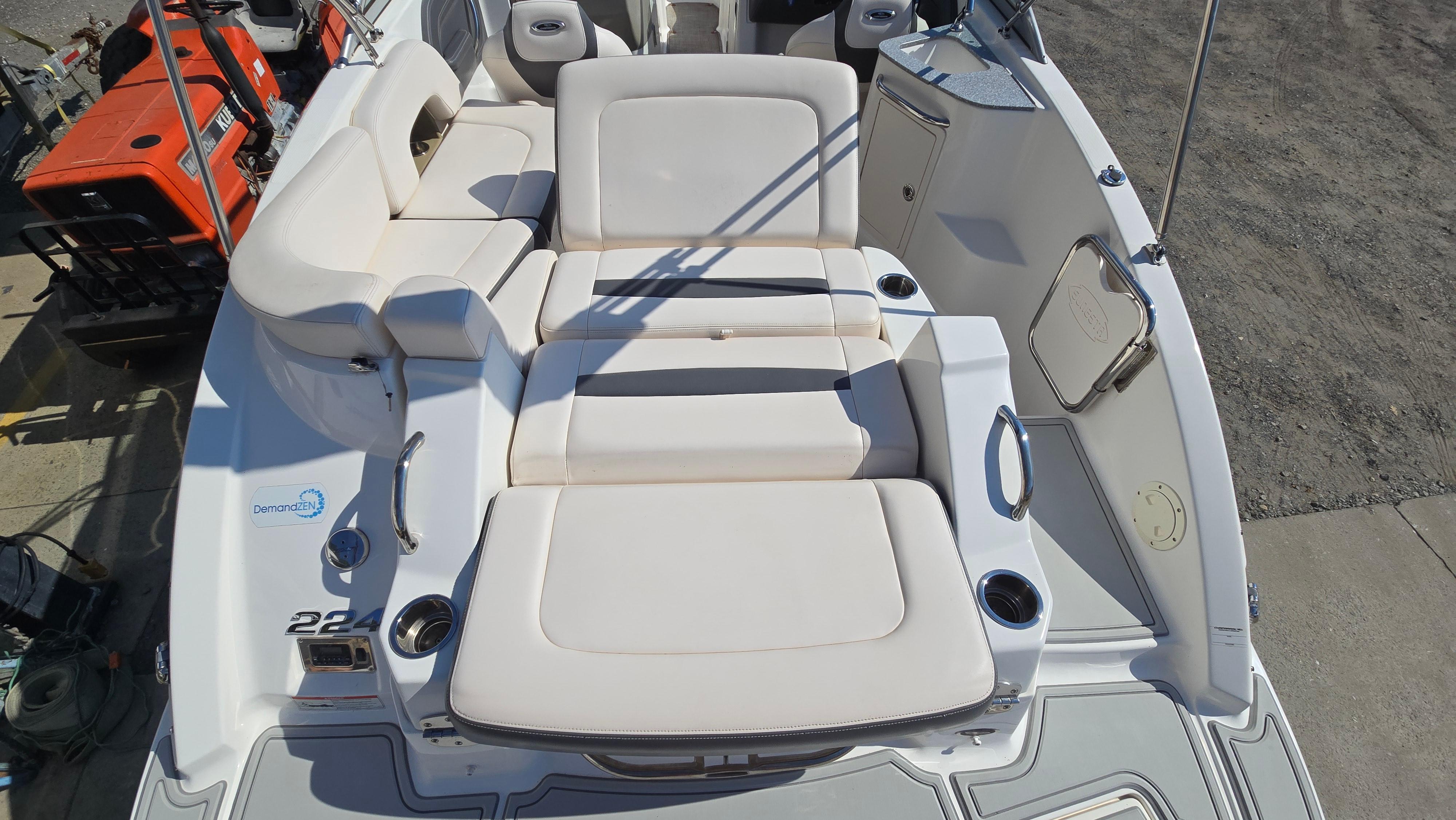 2018 Chaparral 224 Sunesta boat interior with white seating and cup holders.