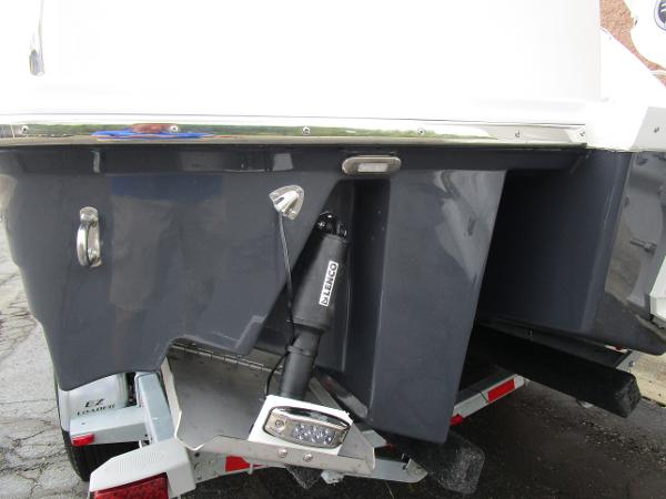 2025 Solara S-250 CW boat stern on trailer, featuring trim tabs and hydraulic system.
