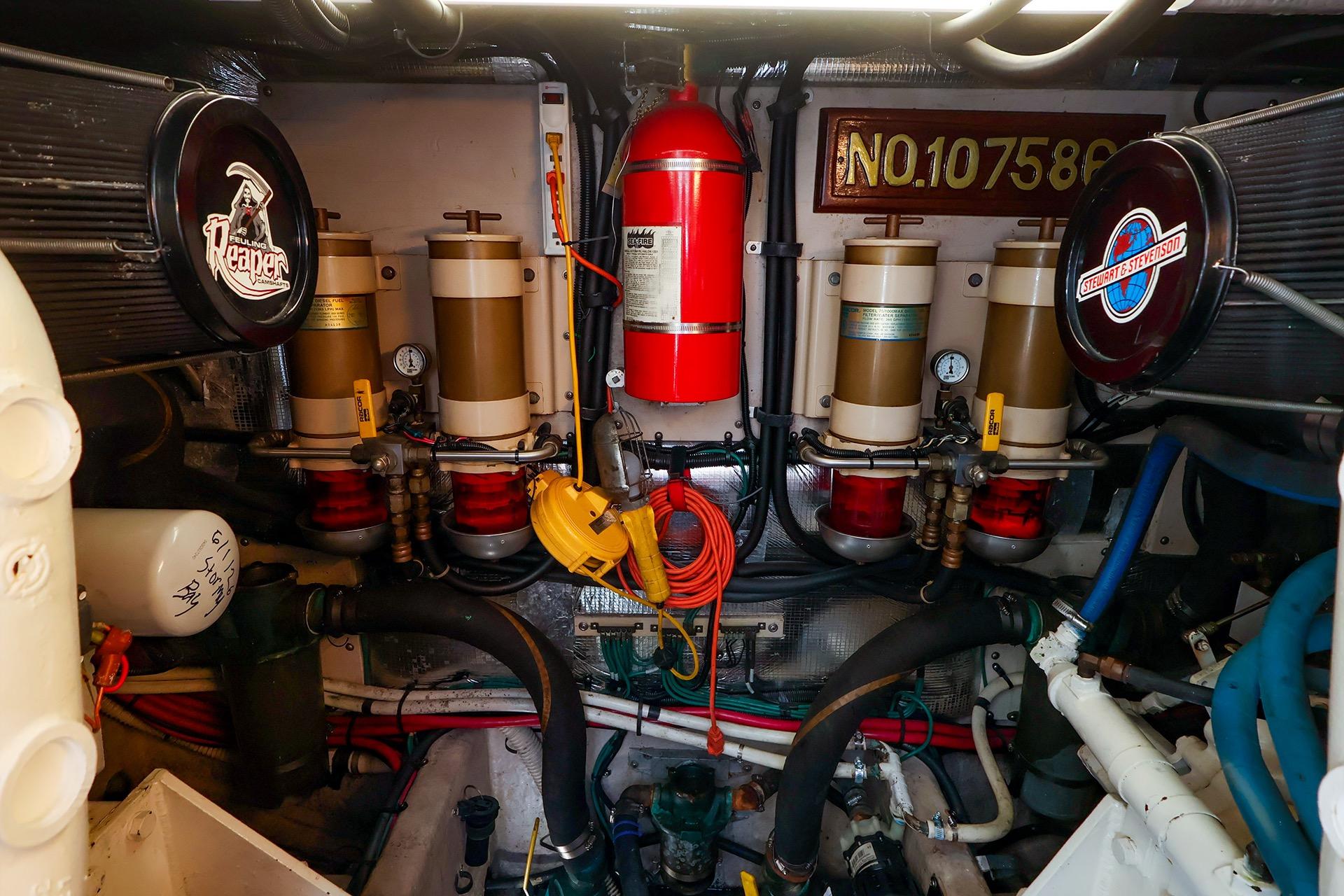 Engine room of a 1998 Sea Ray 500 Sundancer with filters and fire extinguisher.