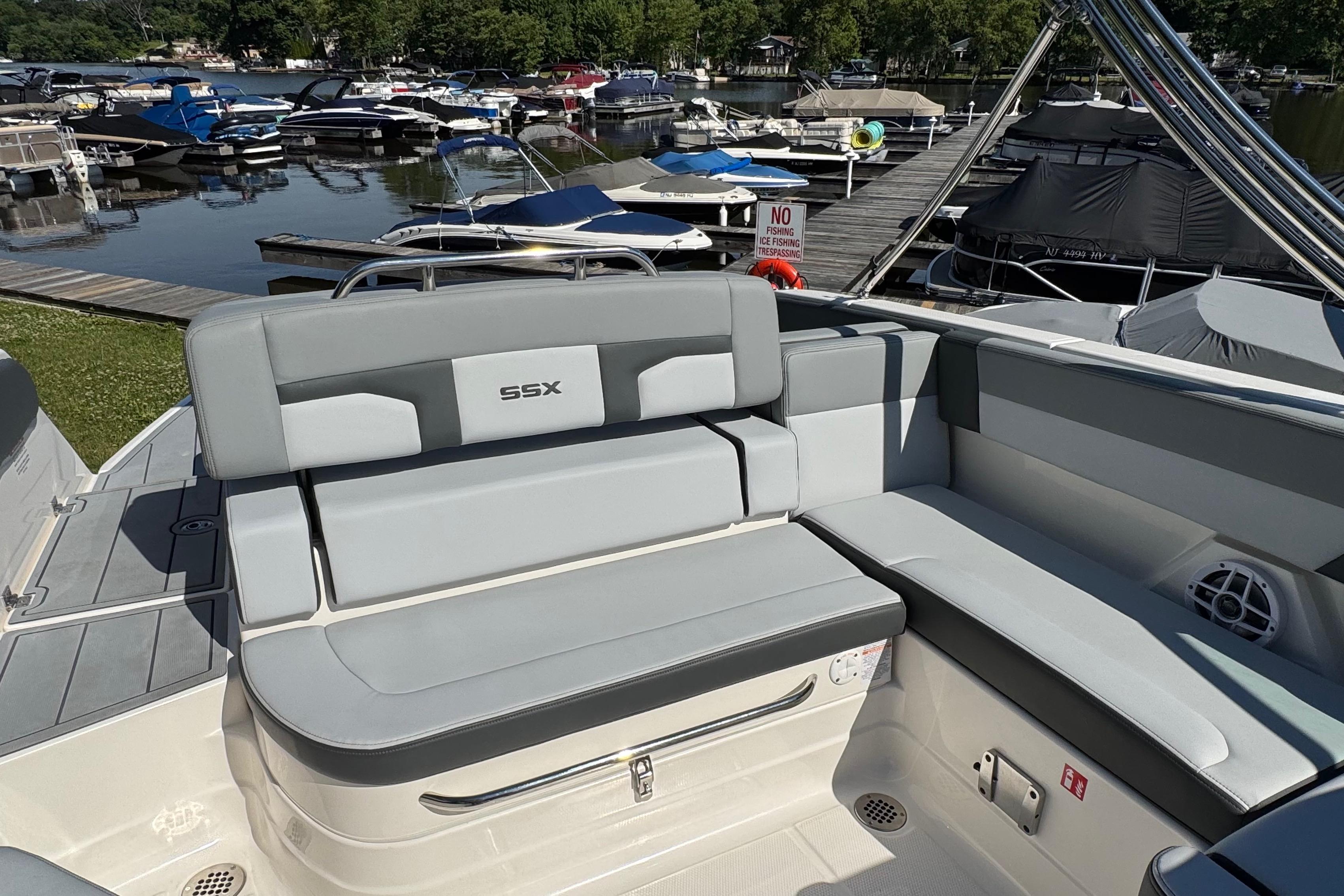 2026 Chaparral SSX 4 boat interior with gray seating at a marina.