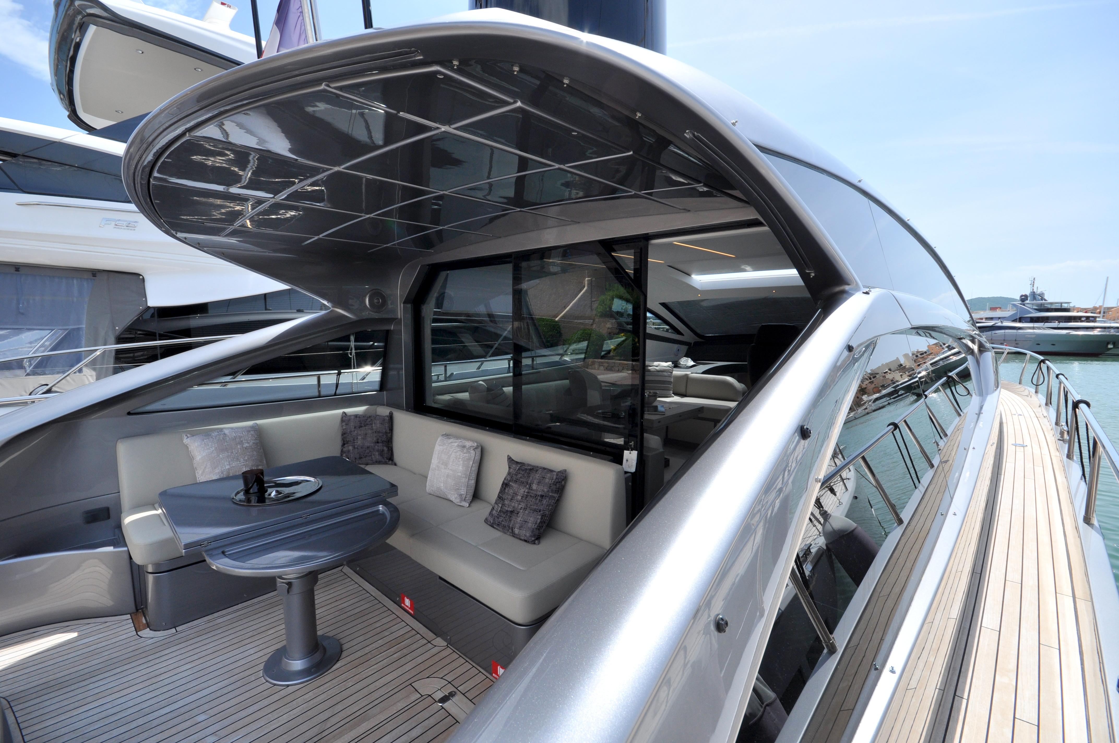 Luxurious 2020 Pershing 62' yacht with sleek design and elegant outdoor seating area.